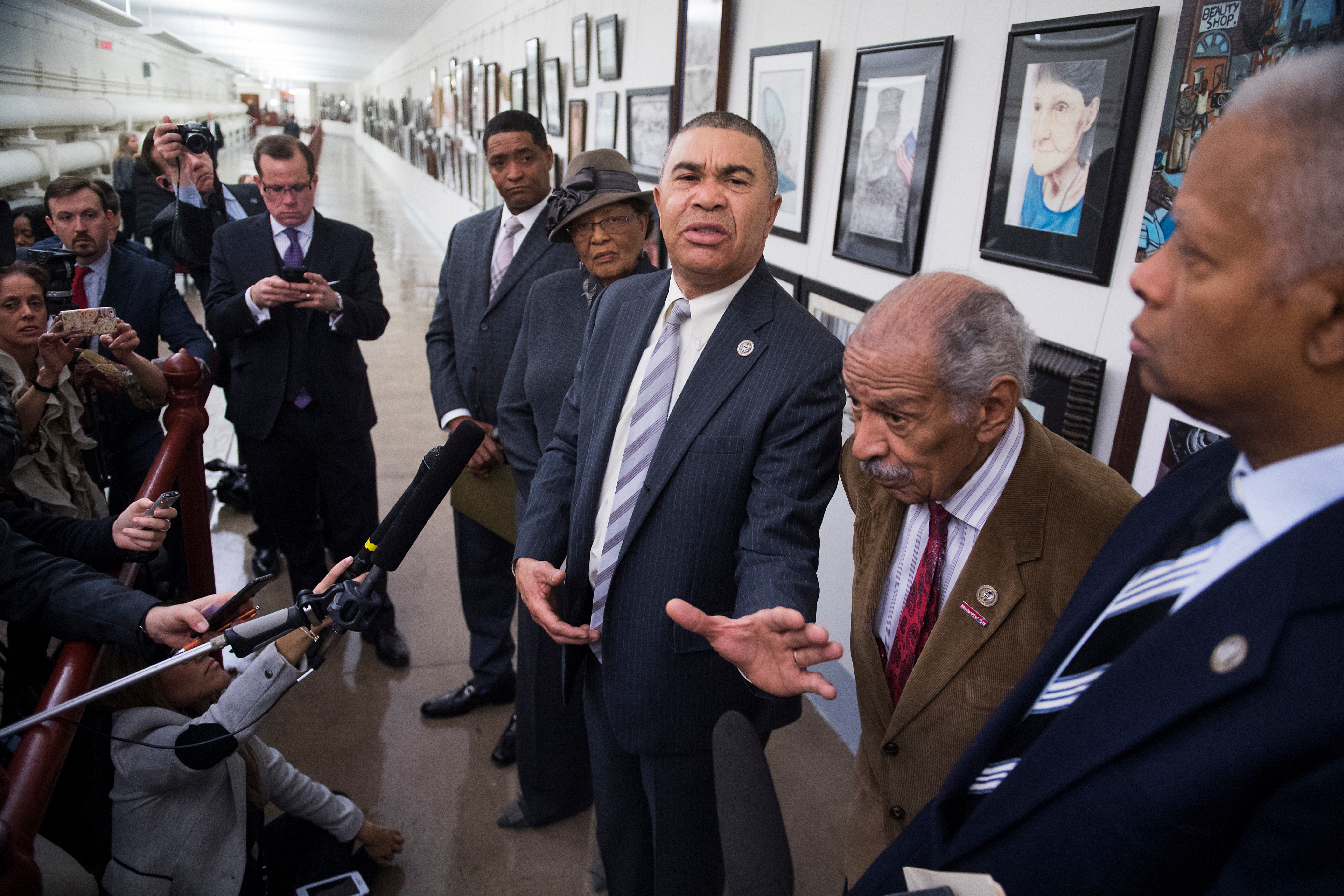 From center left, Reps. <a class="memberLink" title="Click to view member info in a new window" href="http://data.rollcall.com/members/29525?rel=memberLink" target="_blank">Cedric L. Richmond</a> of Louisiana, <a class="memberLink" title="Click to view member info in a new window" href="http://data.rollcall.com/members/52947?rel=memberLink" target="_blank">Alma Adams</a> of North Carolina, <a class="memberLink" title="Click to view member info in a new window" href="http://data.rollcall.com/members/7173?rel=memberLink" target="_blank">William Lacy Clay</a> of Missouri, Conyers, and <a class="memberLink" title="Click to view member info in a new window" href="http://data.rollcall.com/members/25324?rel=memberLink" target="_blank">Hank Johnson</a> of Georgia speak in front of the painting at a press conference in the Capitol tunnel in January. (Tom Williams/CQ Roll Call file photo)