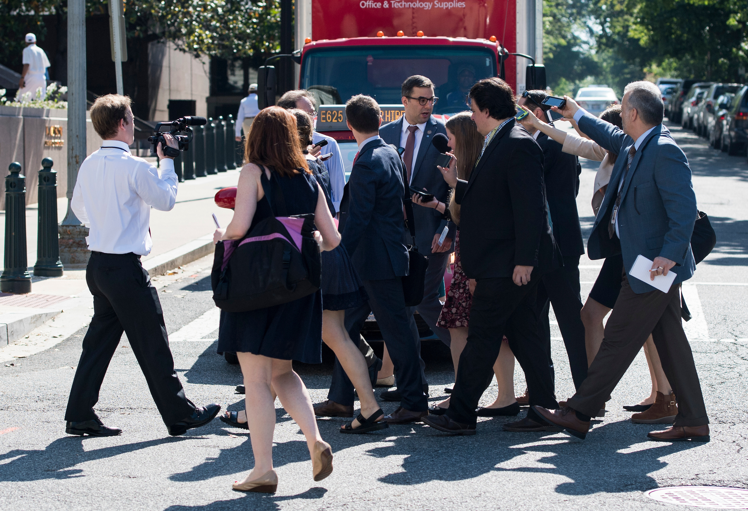 Reporters follow Rep. Justin Amash, R-Mich., across the street as he leaves the House Republican Conference meeting at the Capitol Hill Club in Washington on Wednesday. (Bill Clark/CQ Roll Call)