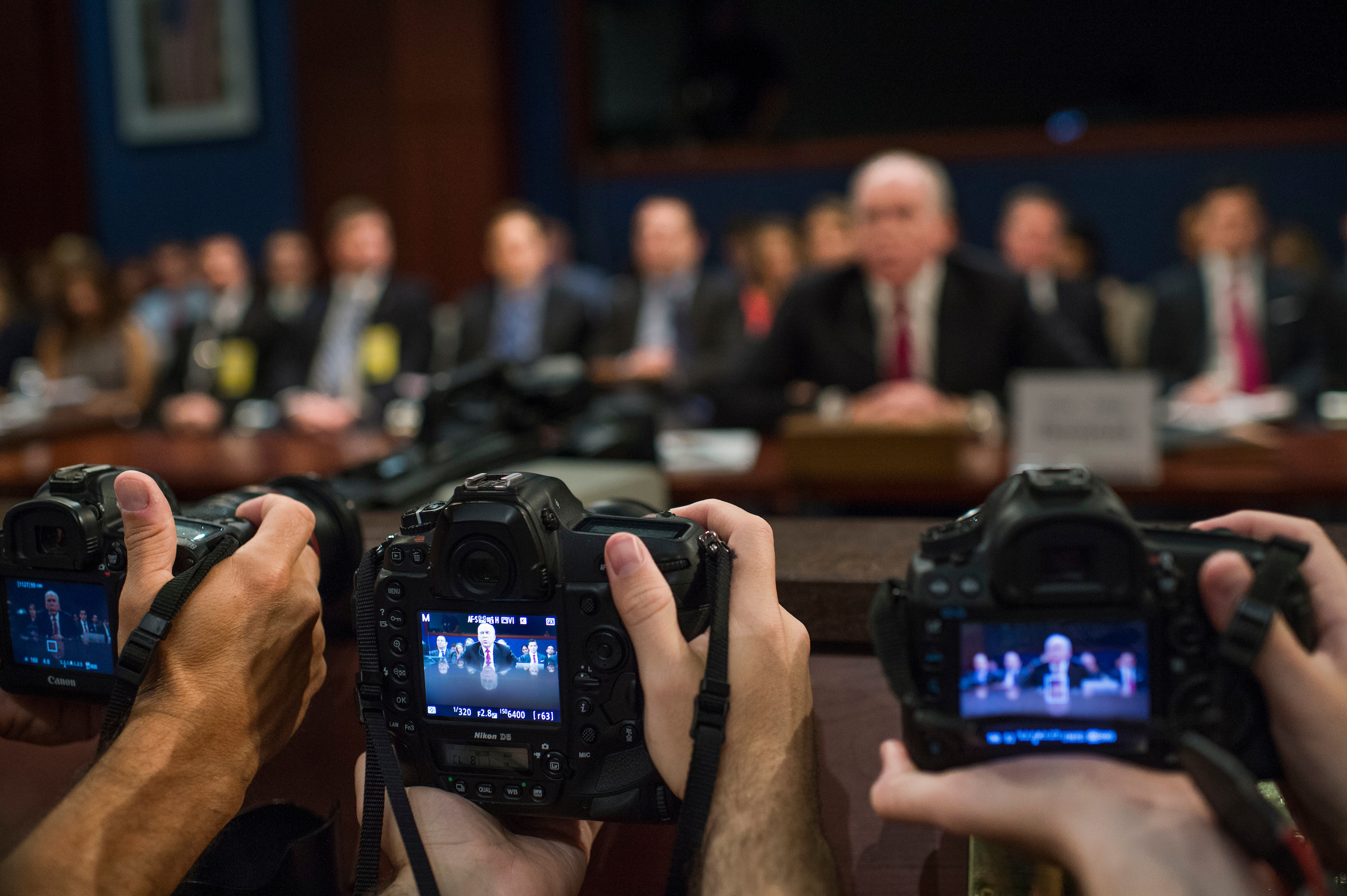 UNITED STATES - MAY 23: Photographers take pictures of former CIA director John Brennan testify before the House Permanent Select Committee on Intelligence in the Capitol Visitor Center on Russian ties to the 2016 election on May 23, 2017. (Photo By Tom Williams/CQ Roll Call)
