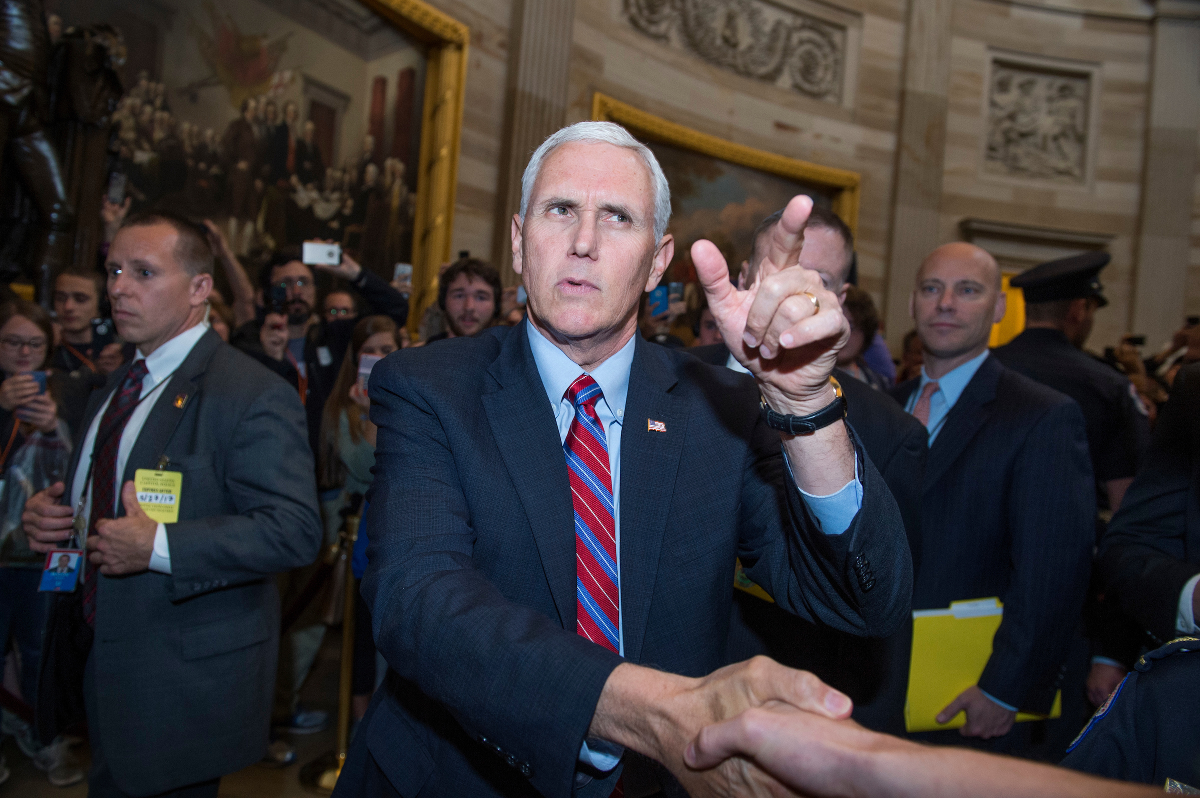 Vice President Mike Pence greets visitors in the Capitol Rotunda after attending the Senate Republican policy luncheon on Tuesday. (Tom Williams/CQ Roll Call)