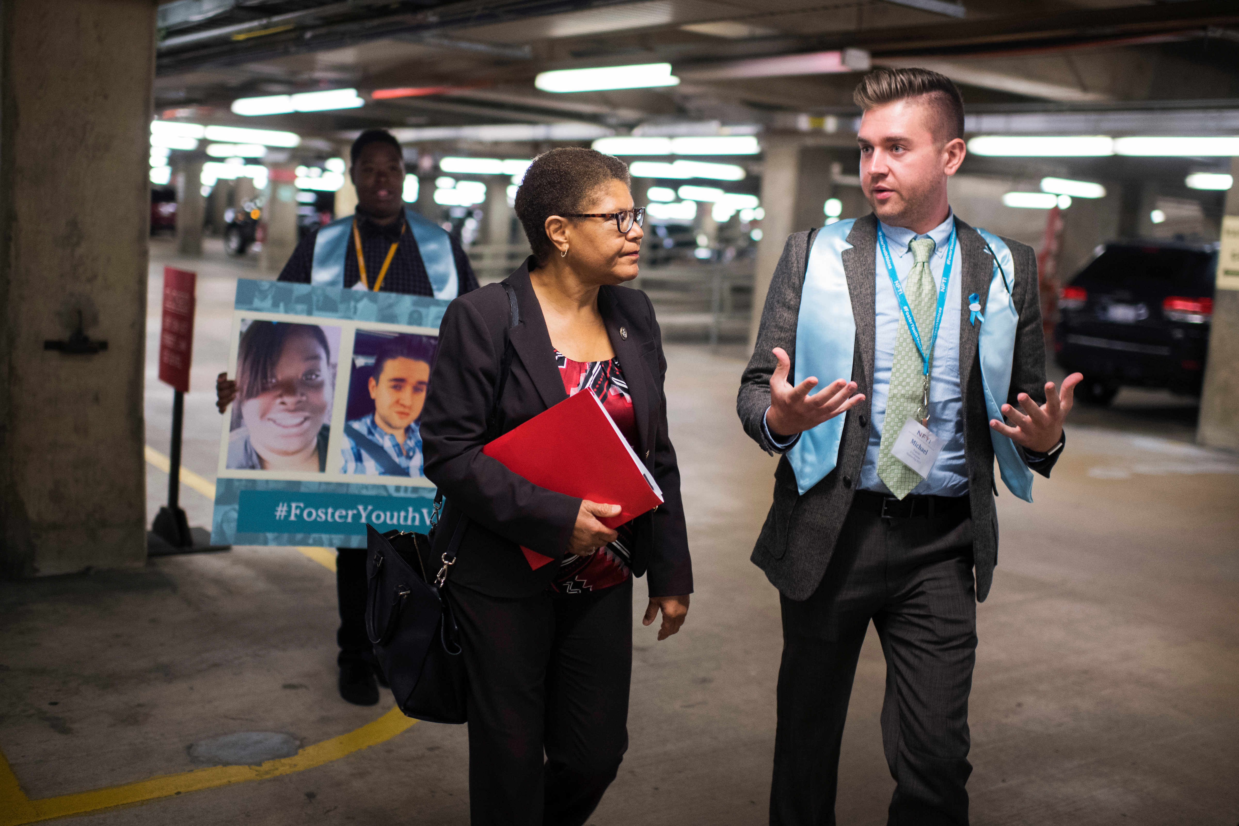 California Rep. <a class="memberLink" title="Click to view member info in a new window" href="http://data.rollcall.com/members/31580?rel=memberLink" target="_blank">Karen Bass</a> talks with Michael Rogalski from Cleveland in the Rayburn parking lot on Wednesday during a shadow day where youth and alumni of foster care learn about Congress from their representatives. (Tom Williams/CQ Roll Call)