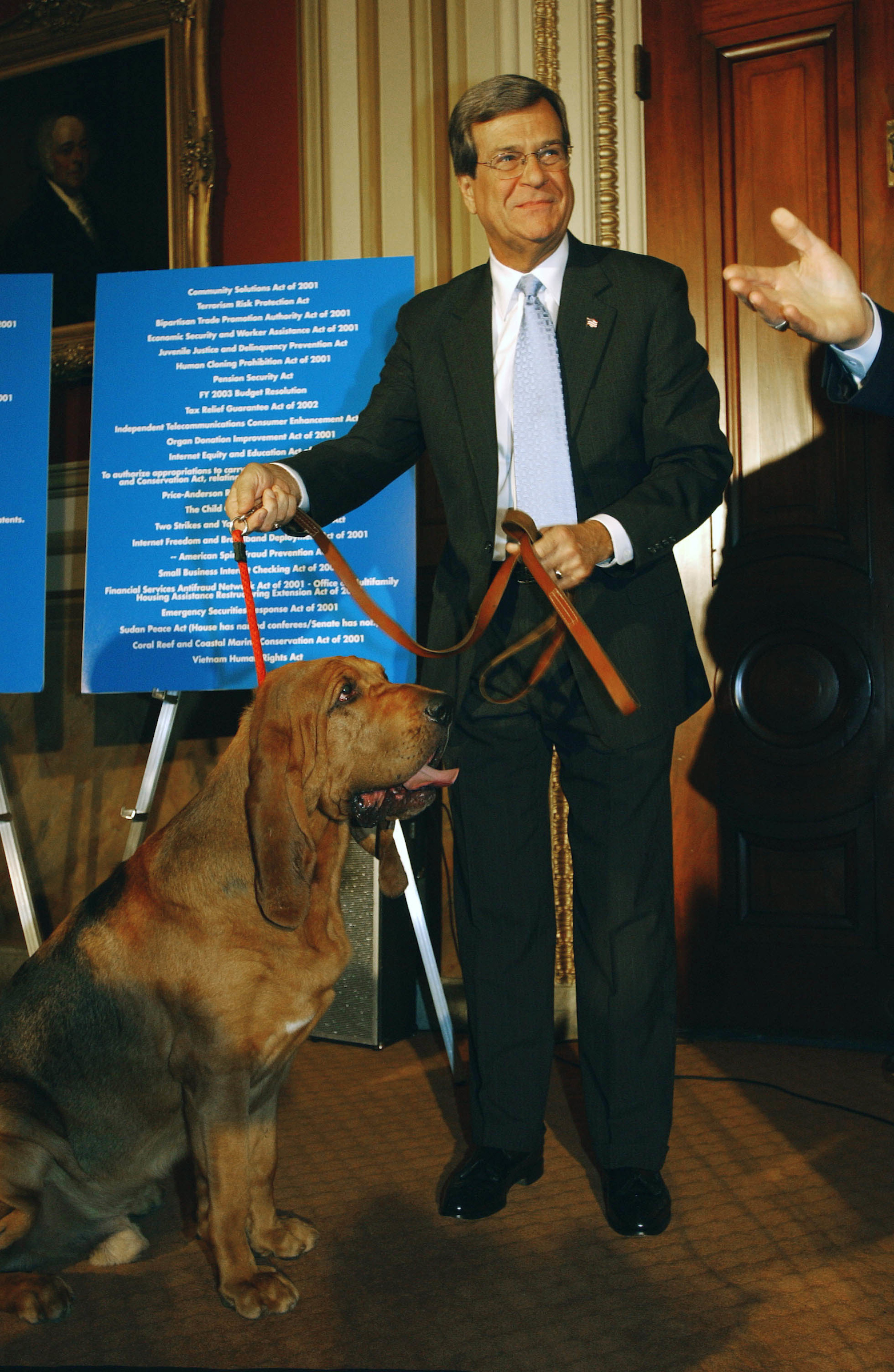 Senate Majority Leader Trent Lott, R-Miss., with bloodhounds at a news conference of GOP Senate leadership criticizing the Democratic leadership on its handling of the Senate agenda. As Lott and others entered the room with the dogs, they coaxed the dogs to "find" legislation that has not yet come to the Senate floor..CONGRESSIONAL QUARTERLY PHOTO BY SCOTT J. FERRELL