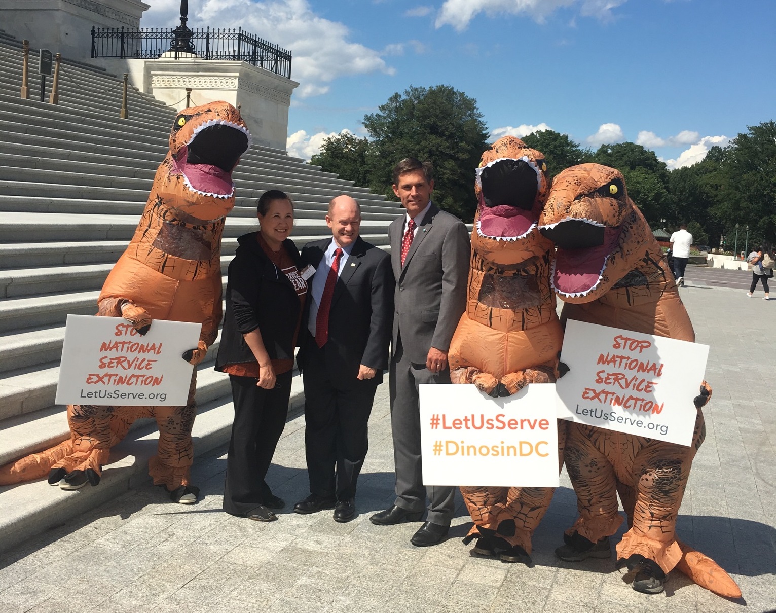 People dressed as dinosaurs pose for a photograph Thursday outside the Capitol with Sens. <a class="memberLink" title="Click to view member info in a new window" href="http://data.rollcall.com/members/32482?rel=memberLink" target="_blank">Chris Coons</a> of Delaware, third from left, and <a class="memberLink" title="Click to view member info in a new window" href="http://data.rollcall.com/members/28678?rel=memberLink" target="_blank">Martin Heinrich</a> of New Mexico, fourth from left. (Katherine Tully-McManus/CQ Roll Call)
