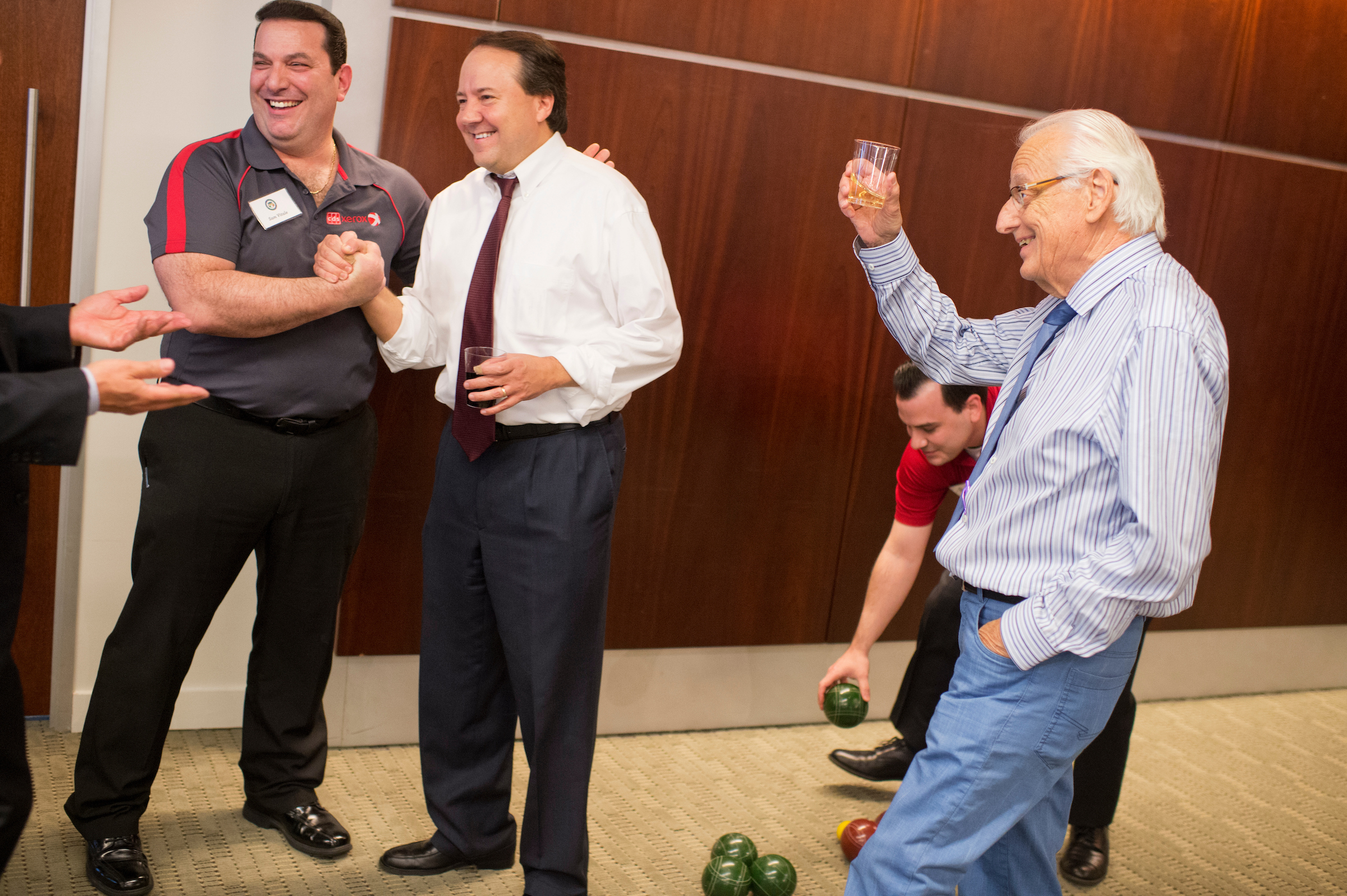 UNITED STATES - MAY 23: From left, Sam Vitale of Xerox, Rep. Pat Tiberi, R-Ohio, Jon Vitale, and Rep. Bill Pascrell, D-N.J., conclude a match where the Congress team was victorious during the Fourth Annual Congressional Bocce Ball Tournament sponsored by the National Italian American Foundation (NIAF), in the offices of Venable LLP law firm, May 23, 2016. Play was moved inside because of rain. (Photo By Tom Williams/CQ Roll Call)