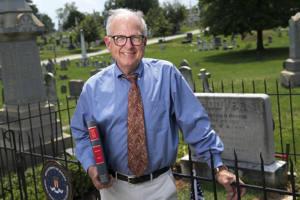 Charles Francis, president of the Mattachine Society of Washington, D.C., in front of J. Edgar Hoover's grave at Congressional Cemetery. He holds an amicus brief of Obergefell v. Hodges, which found that same-sex marriage is constitutional. (Tom Williams/CQ Roll Call file photo)