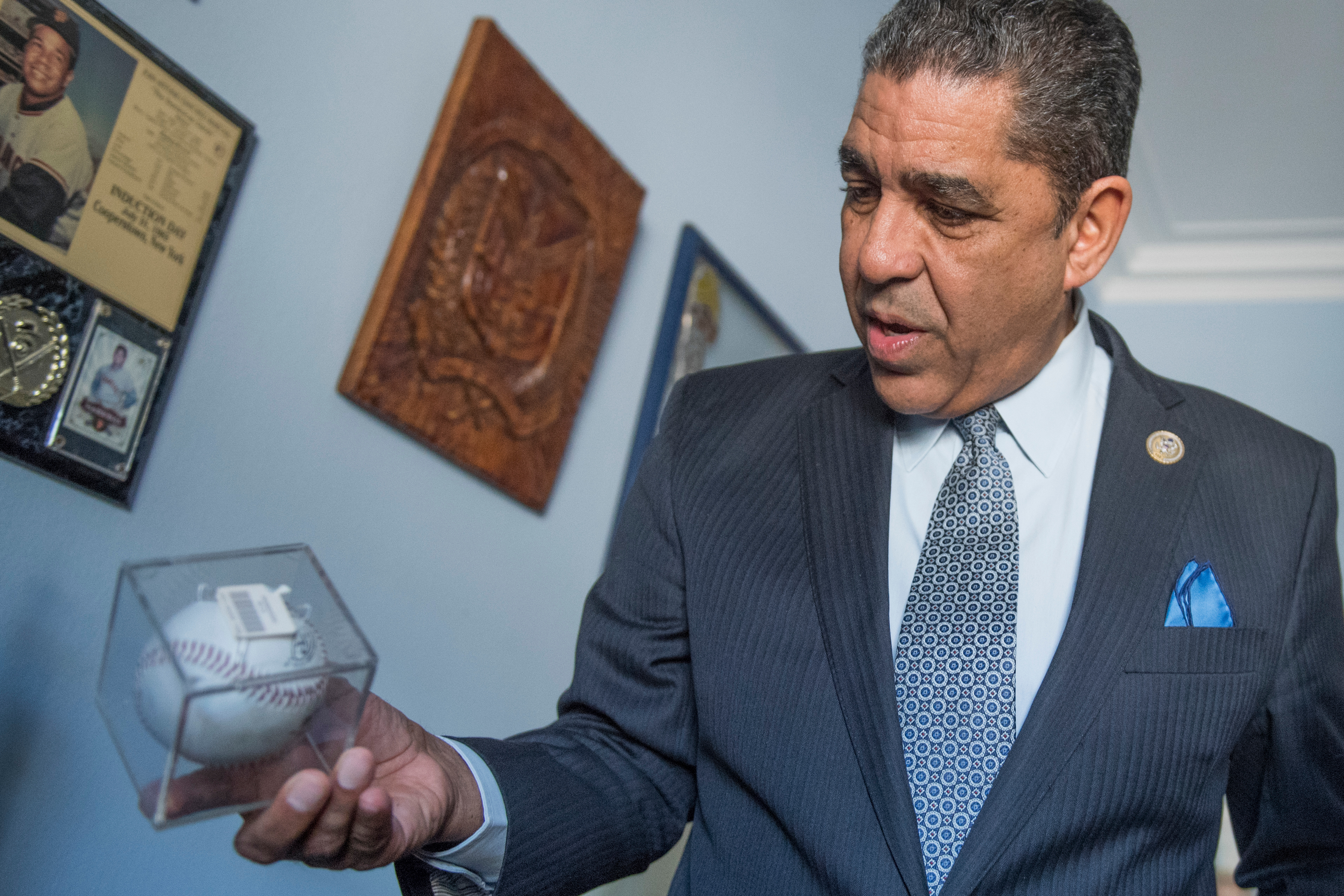 Rep. Adriano Espaillat, D-N.Y., is putting together a display of his baseball memorabilia in his Longworth office. (Tom Williams/CQ Roll Call)