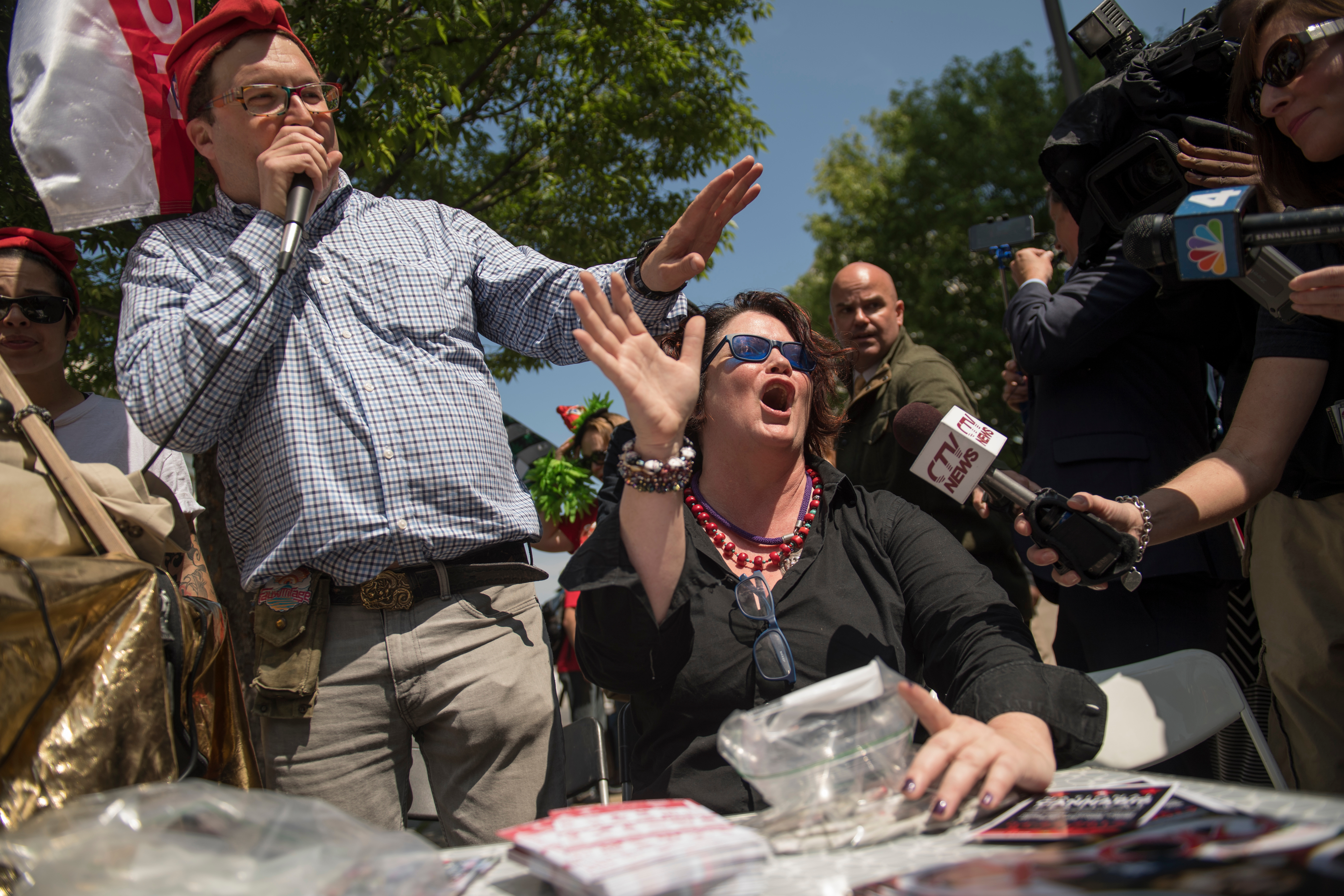 UNITED STATES - APRIL 20: Adam Eidinger of DCMJ, left, and Elizabeth Croydon, hand out joints during the 1st Annual Congressional #JointSession pot giveaway to credentialed Hill staff and the media at Constitution Ave. and First St. NE on April 20, 2017. The event was held by the DCMJ to call on Congress to reauthorize an amendment that prevents federal legal intervention in the District's marijuana laws. (Photo By Tom Williams/CQ Roll Call)