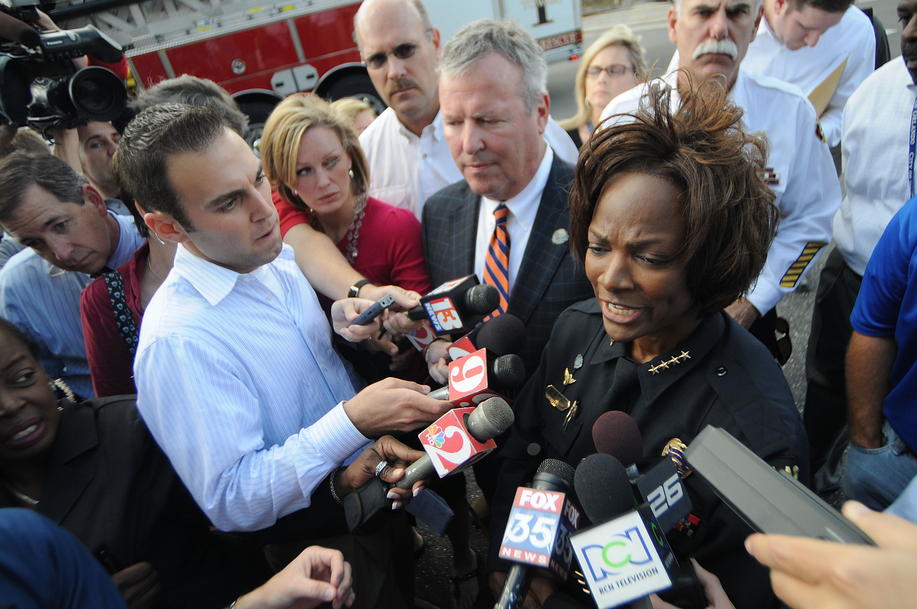 Demings, as Orlando police chief, speaks to reporters with Orlando Mayor Buddy Dyer, center, near the site of an office building where a gunman opened fire, killing one person and wounding several others, in 2009. (Gerardo Mora/Getty Images file photo)