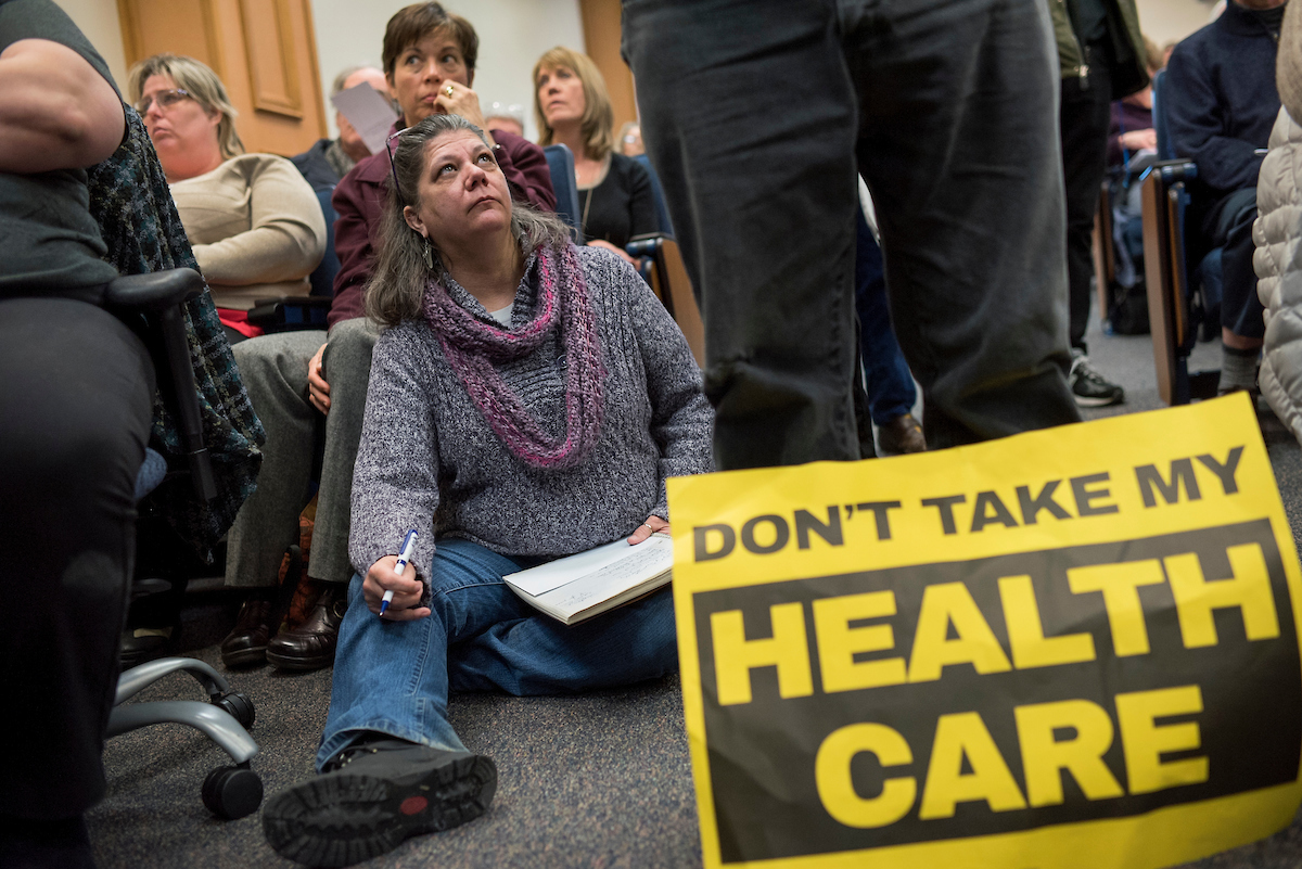 Both parties are wasting no time in their post-health care vote messaging. Here, Lillian Potter-Saum listens to West Virginia Democratic Sen. Joe Manchin III at a town hall meeting in Martinsburg, W.Va., in March. (Tom Williams/CQ Roll Call File Photo)