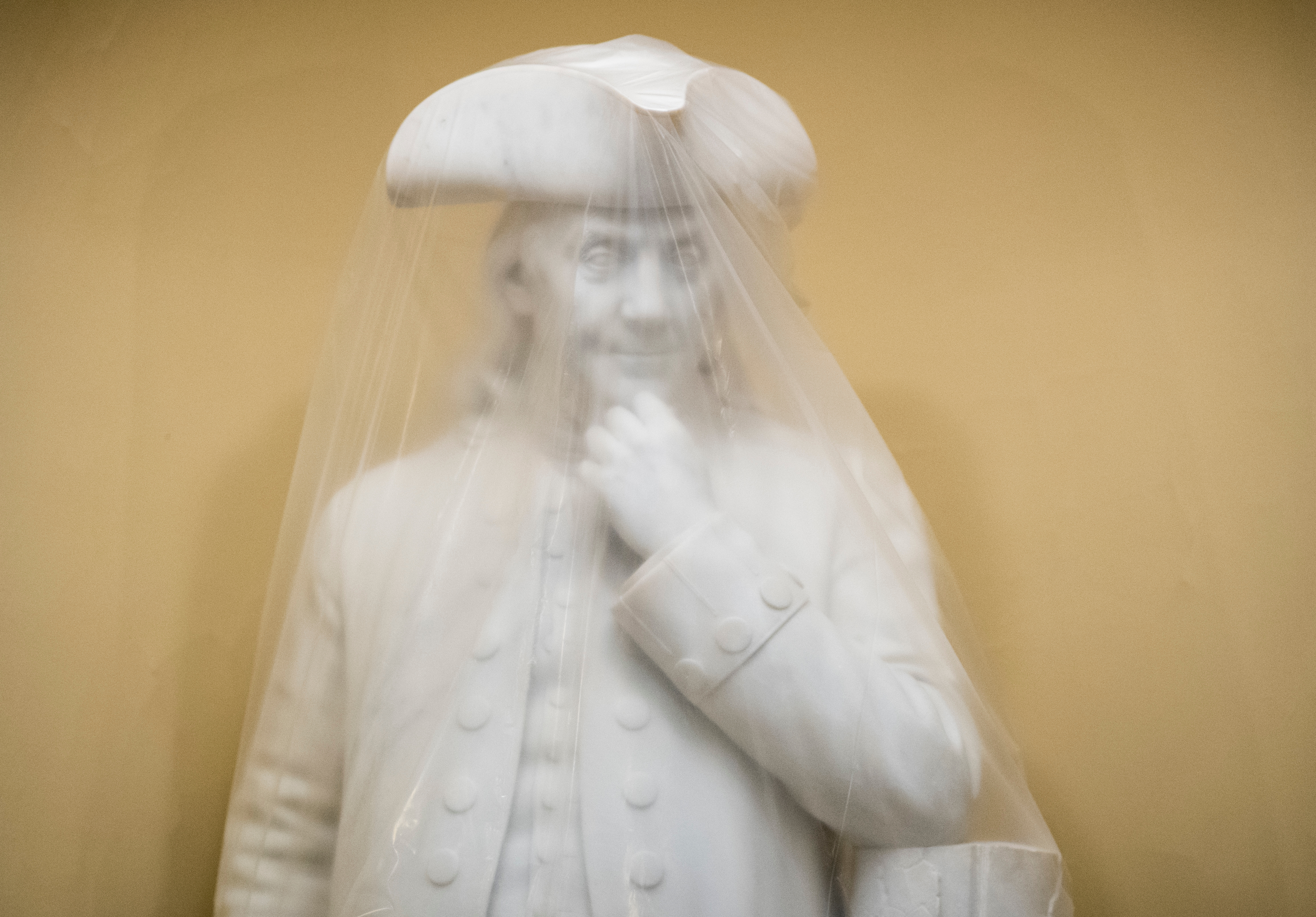A plastic sheet covers the statue of Ben Franklin in the Capitol on Wednesday, May 10, 2017. (Photo By Bill Clark/CQ Roll Call)
