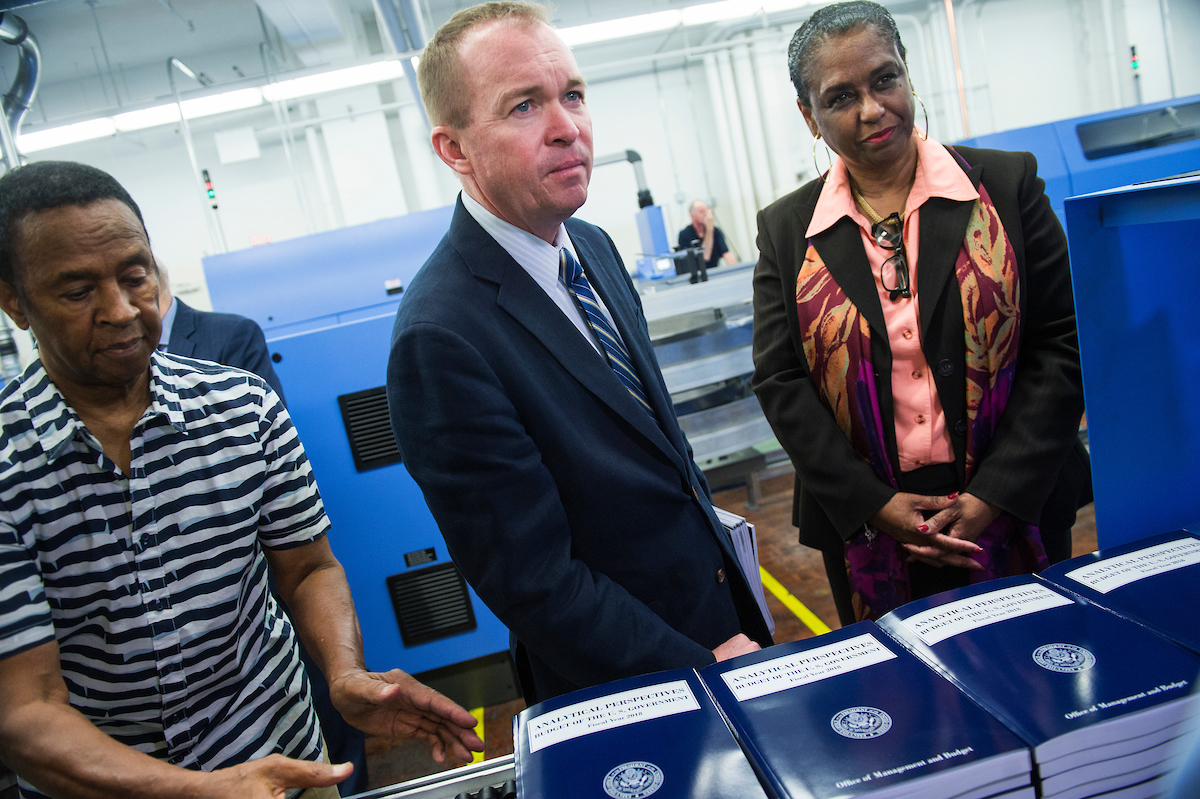 OMB Director Mick Mulvaney, center, and GPO Director Davita Vance-Cooks, right, reviewed production of the fiscal 208 budget proposal at the Government Publishing Office’s plant on North Capitol Street last week. (Tom Williams/CQ Roll Call)