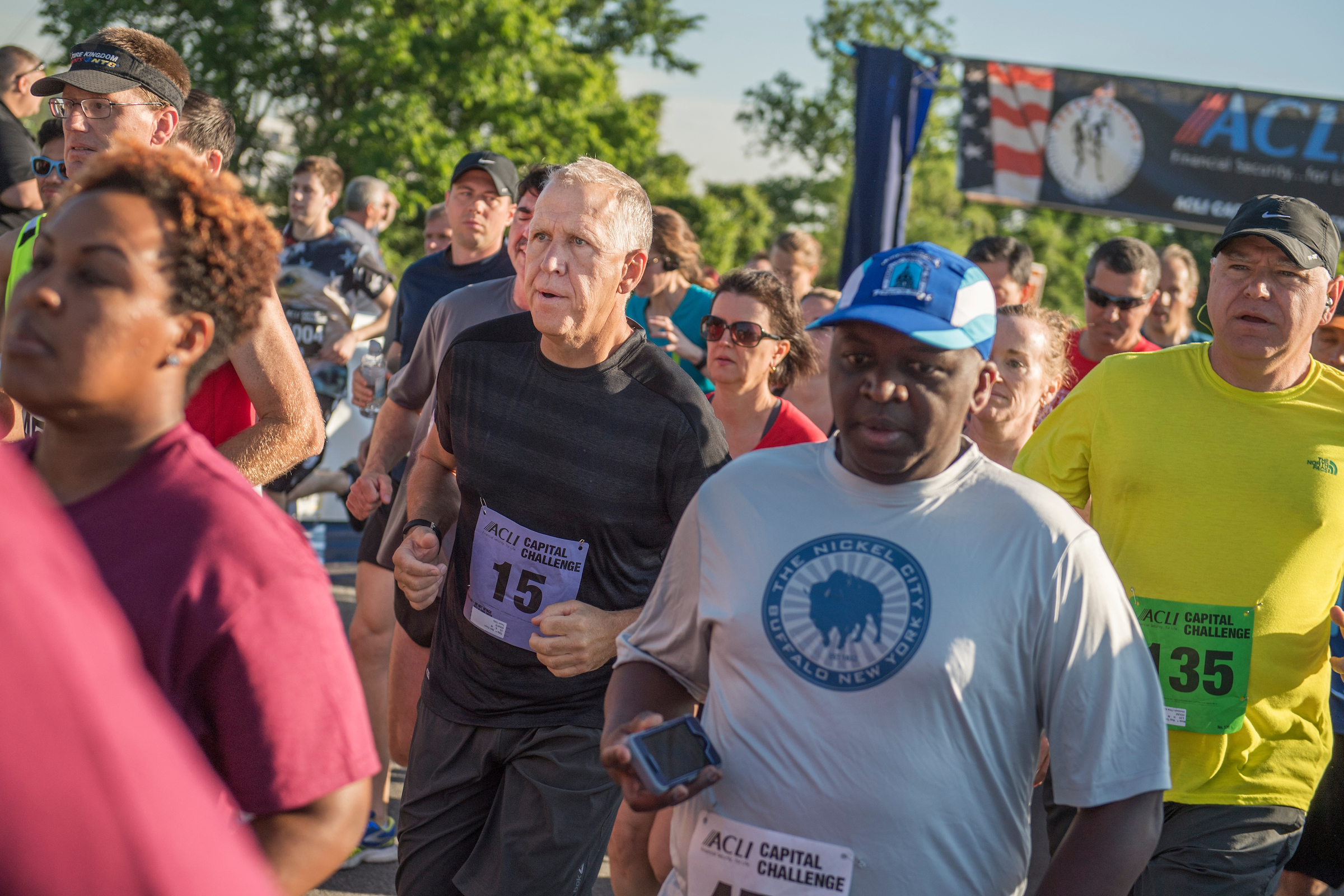 UNITED STATES - MAY 17: Sen. Thom Tillis, R-N.C., black shirt, and Rep. Tim Walz, D-Minn., yellow shirt, run in the ACLI Capital Challenge 3 Mile Team Race in Anacostia Park, May 17, 2017. Tillis reportedly collapsed later in the race. (Photo By Tom Williams/CQ Roll Call)