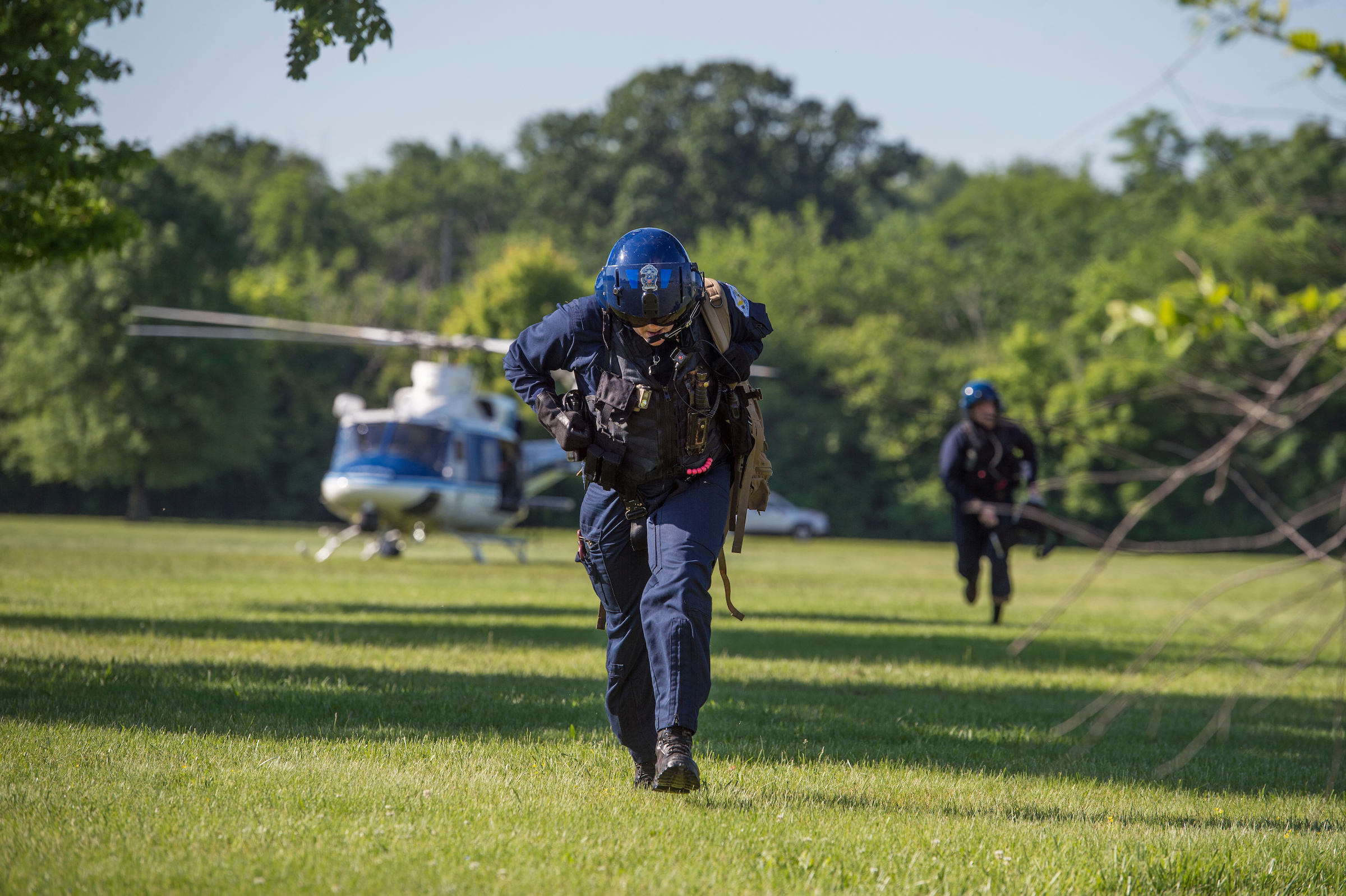 UNITED STATES - MAY 17: Medical personnel rush to treat a fallen runner during the ACLI Capital Challenge 3 Mile Team Race in Anacostia Park, May 17, 2017. The runner was flown out via helicopter. (Photo By Tom Williams/CQ Roll Call)