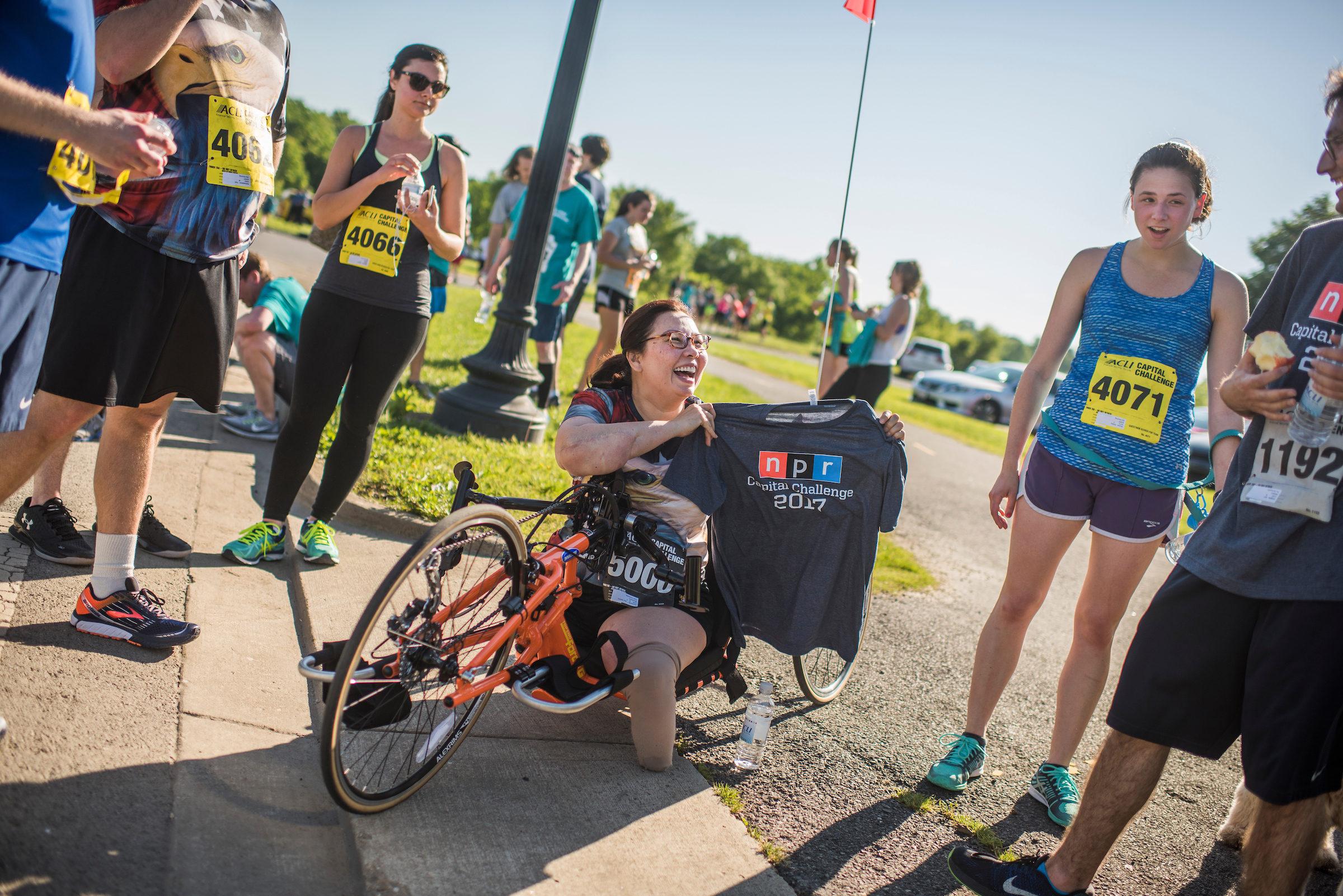 UNITED STATES - MAY 17: Sen. Tammy Duckworth, D-Ill., receives a shirt from the NPR team after the ACLI Capital Challenge 3 Mile Team Race in Anacostia Park, May 17, 2017. (Photo By Tom Williams/CQ Roll Call)