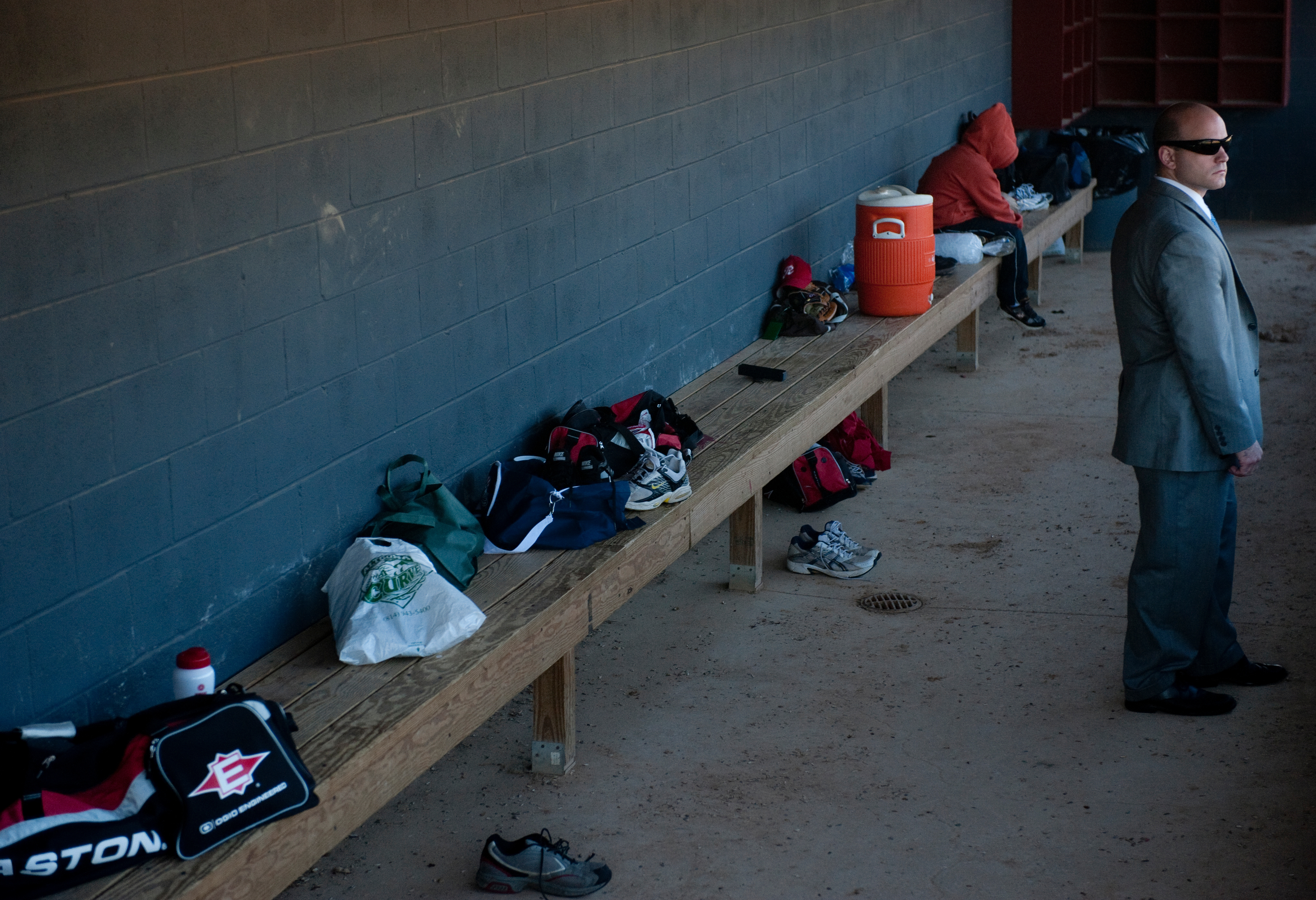 A Capitol Police officer keeps an eye on the Republicans’ baseball practice from the dugout at Four Mile Run Park in Alexandria, Va., in June 2015. (Bill Clark/Roll Call file photo)