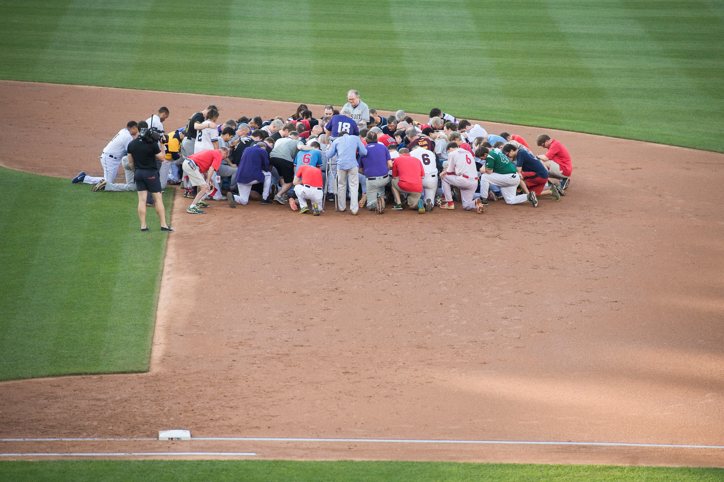 Players pray for the victims of the shooting at the Republican baseball practice before the 56th Congressional Baseball Game at Nationals Park. (Tom Williams/CQ Roll Call)