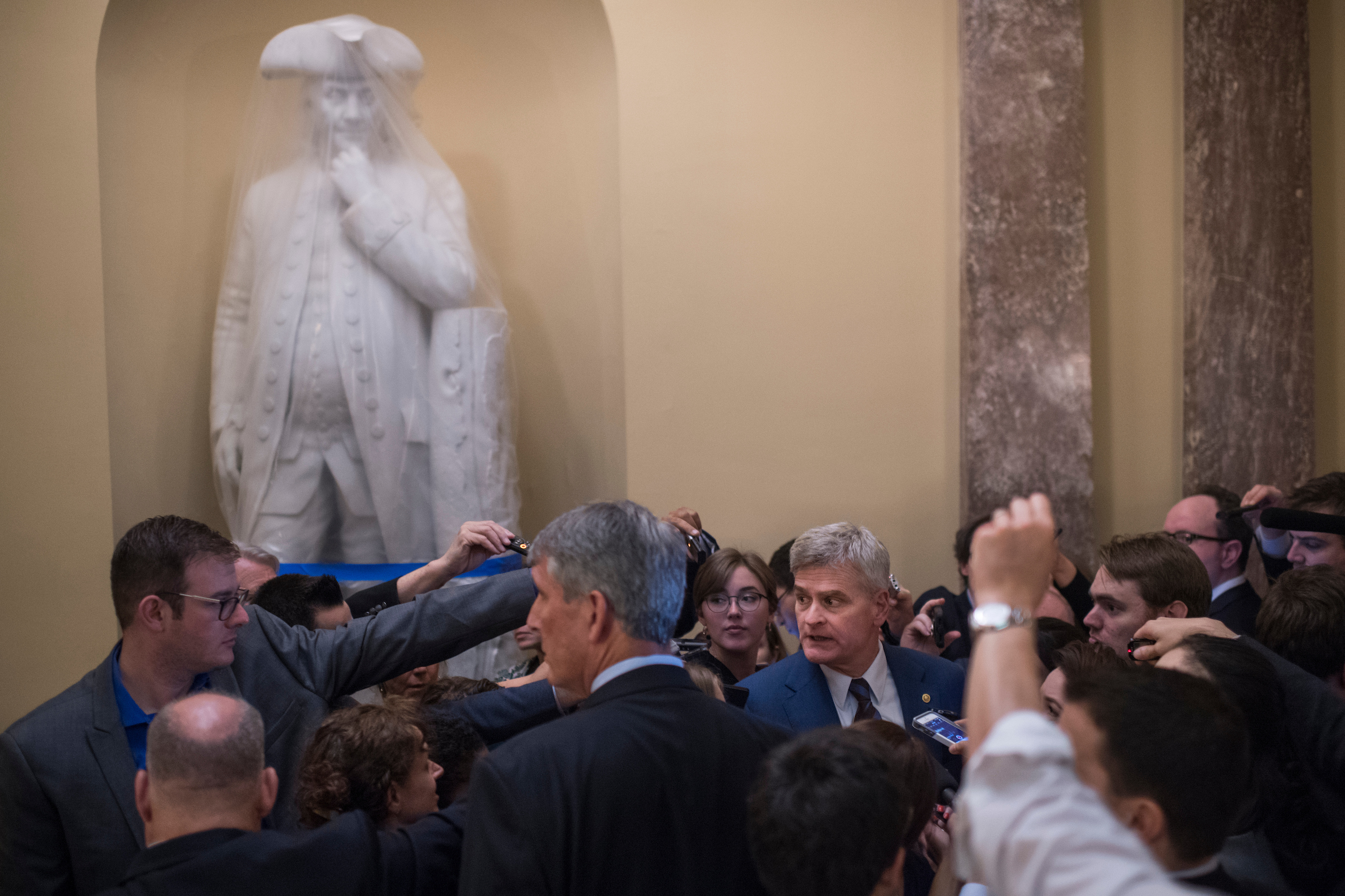 Louisiana Sen. Bill Cassidy talks with reporters Thursday after a meeting in the Capitol on the Senate Republicans’ health care draft. (Tom Williams/CQ Roll Call)