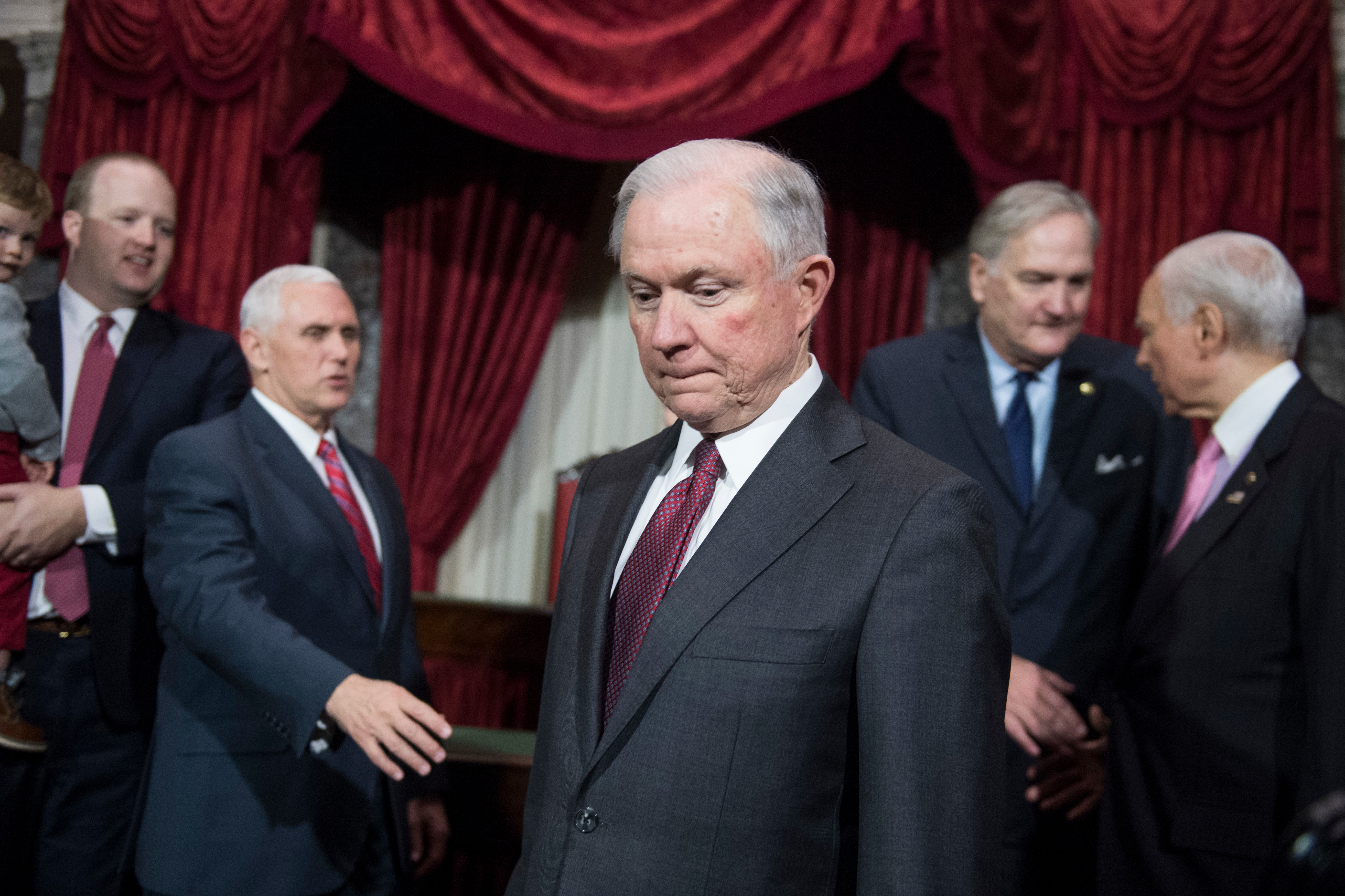 Attorney General Jeff Sessions, center, is seen with Vice President Mike Pence, second from left, and senators in the Capitol’s Old Senate Chamber in February. On Wednesday, Pence said he and President Trump are “proud” to have the former Alabama senator as attorney general. (Tom Williams/CQ Roll Call file photo)