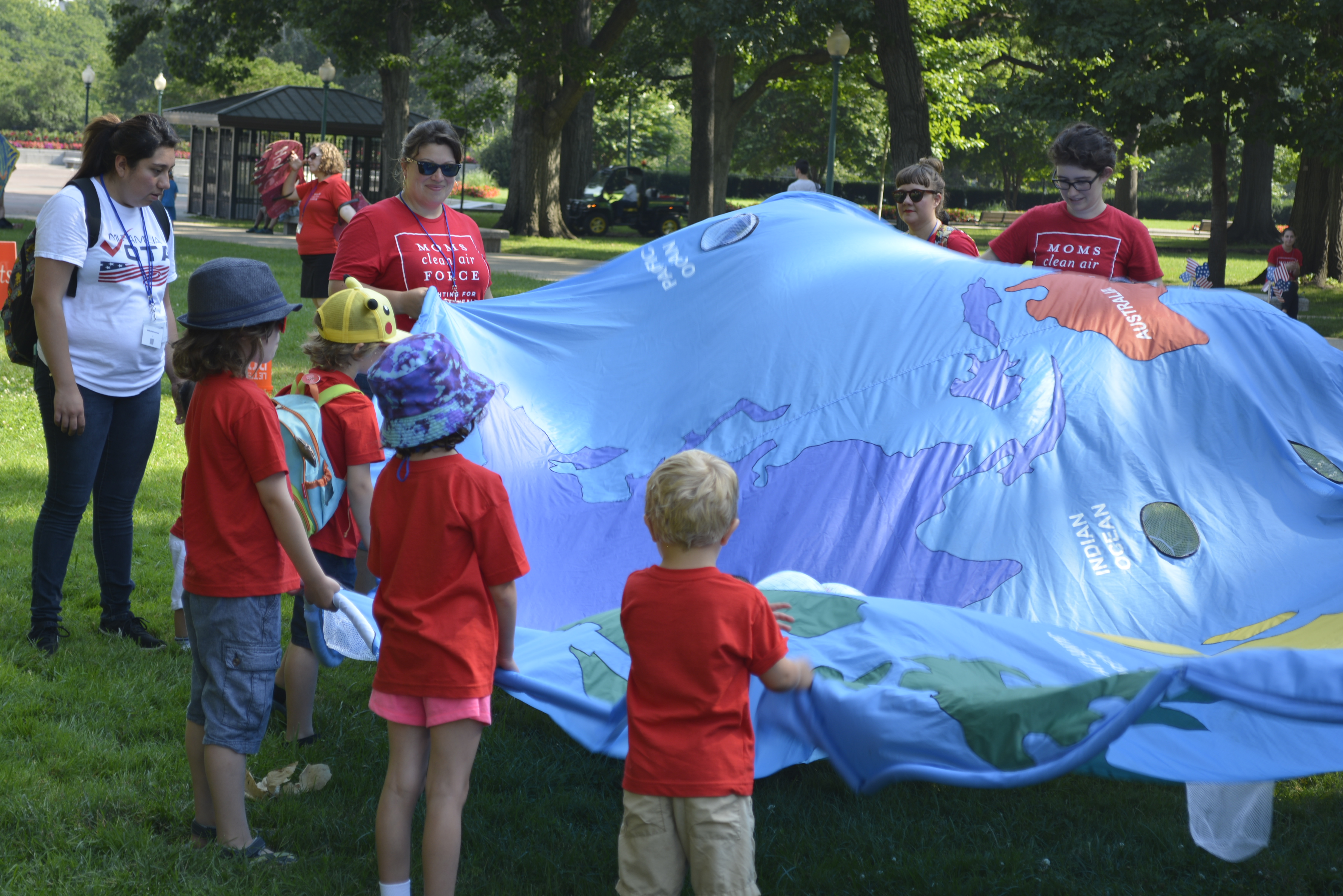 Children join in as organizers set up a play area on the Upper Senate Lawn Thursday as part of the fourth annual “play in” demonstration on the Hill organized by Moms Clean Air Force. (Griffin Connolly/CQ Roll Call)