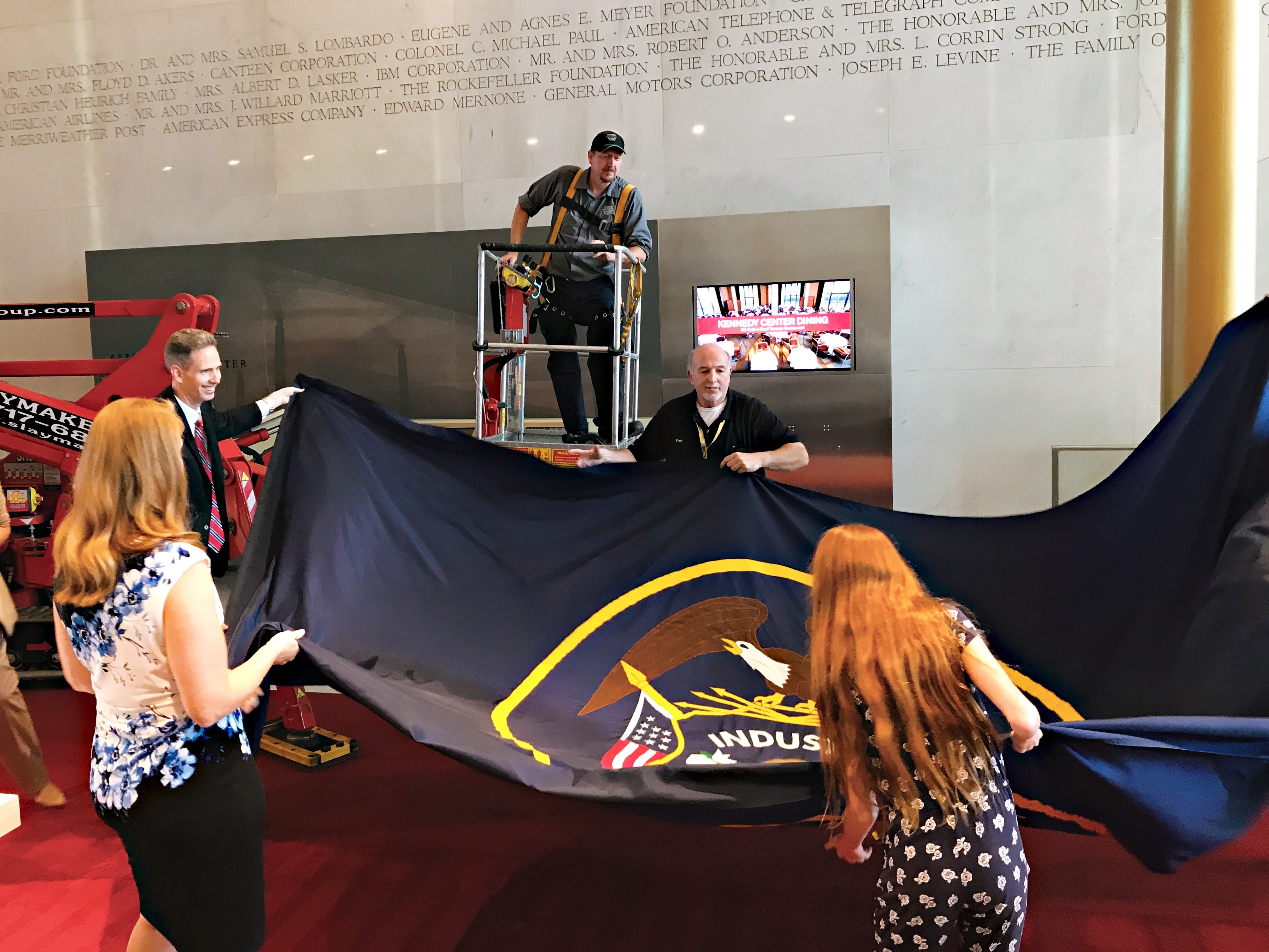 Staffer Ryan Martin and his family check out the Utah flag before it goes up in the Kennedy Center's Hall of States. (Kennedy Center)