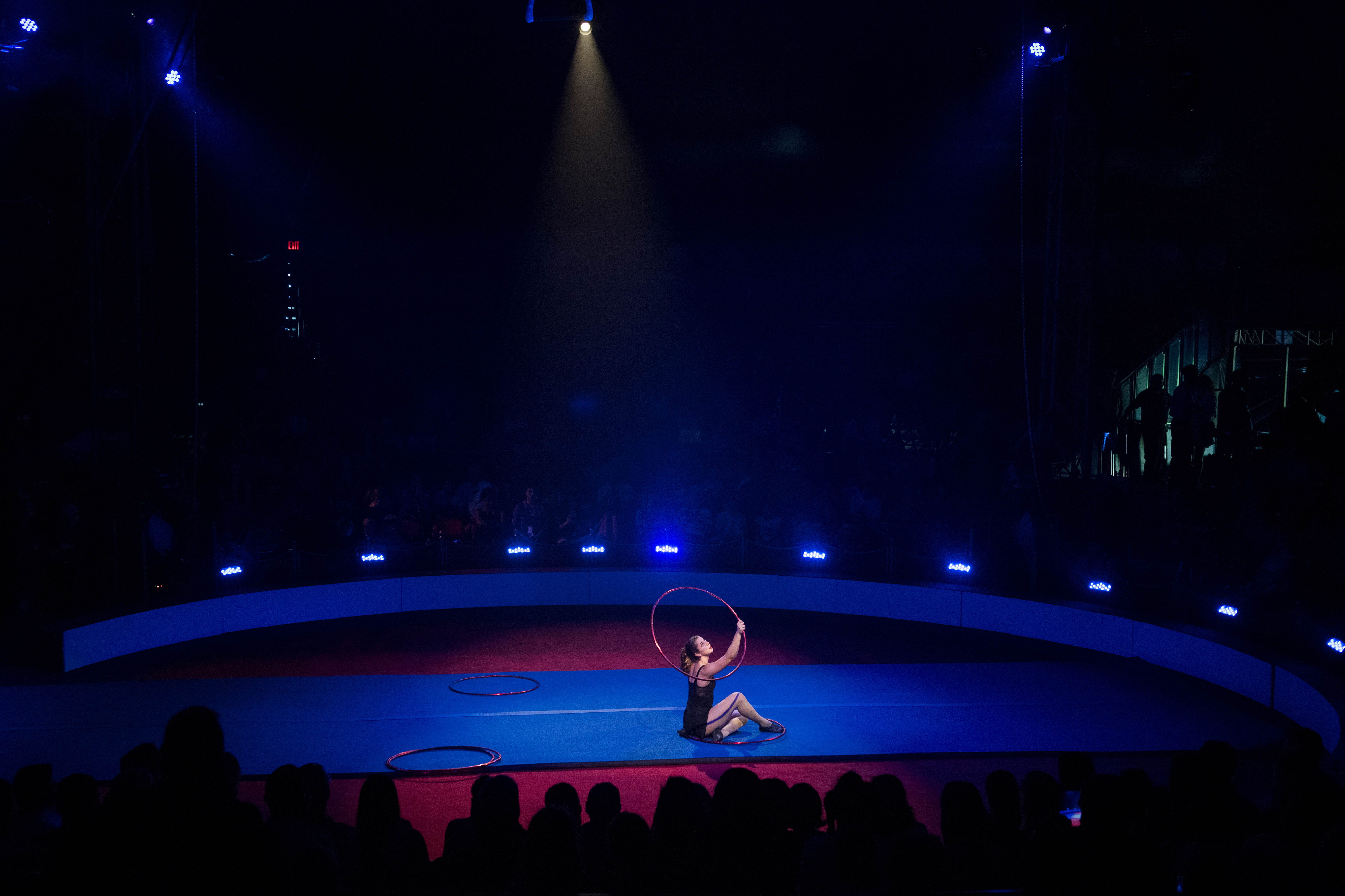 A member of Circus Harmony in Florissant, Mo., performs with rings in the big top at the Smithsonian Folklife Festival on the Mall on Thursday. (Tom Williams/CQ Roll Call)