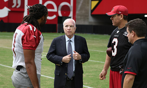 Larry Fitzgerald, Sen. John McCain., Carson Palmer and president Michael Bidwill pose for a photo at the Arizona Cardinals’ training camp