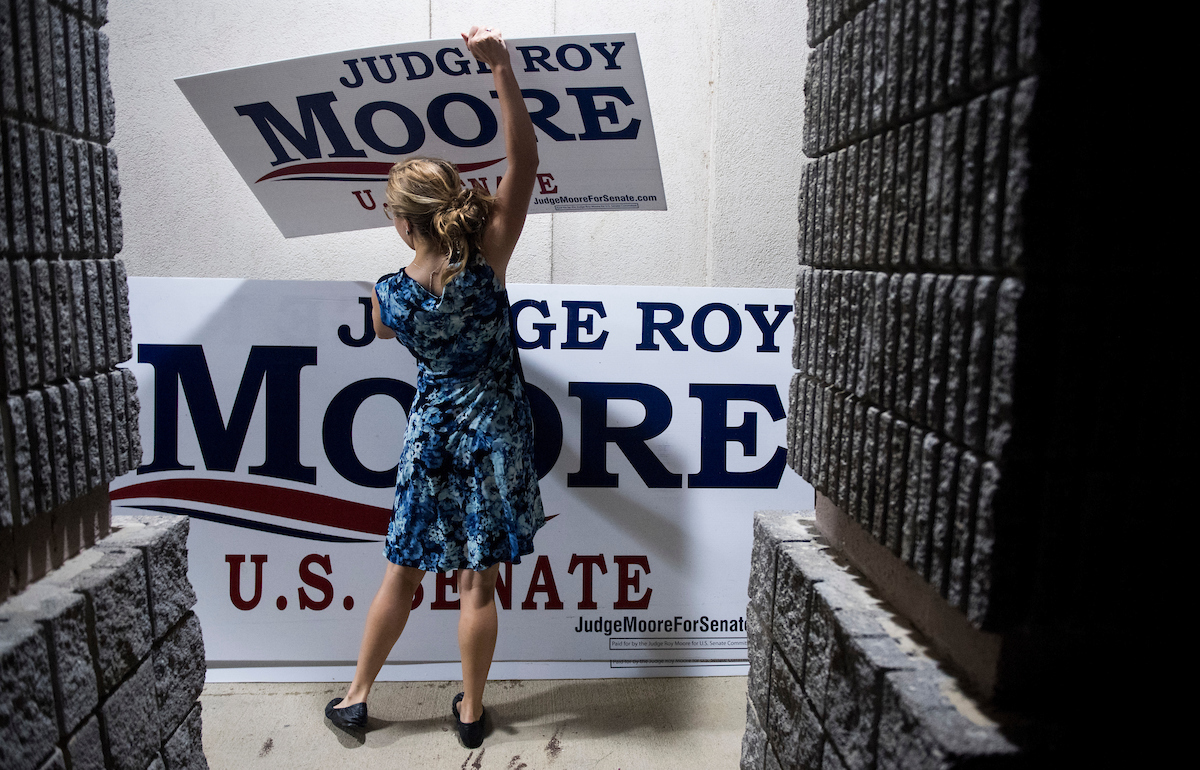 Judge Roy Moore campaign worker Maggie Ford collects campaign signs after the U.S. Senate candidate forum held by the Shelby County Republican Party in Pelham, Ala., on Friday, Aug. 4, 2017. Moore won the special election GOP runoff to fill the seat vacated by Attorney General Jeff Sessions, according to preliminary results from the AP. (Bill Clark/CQ Roll Call)