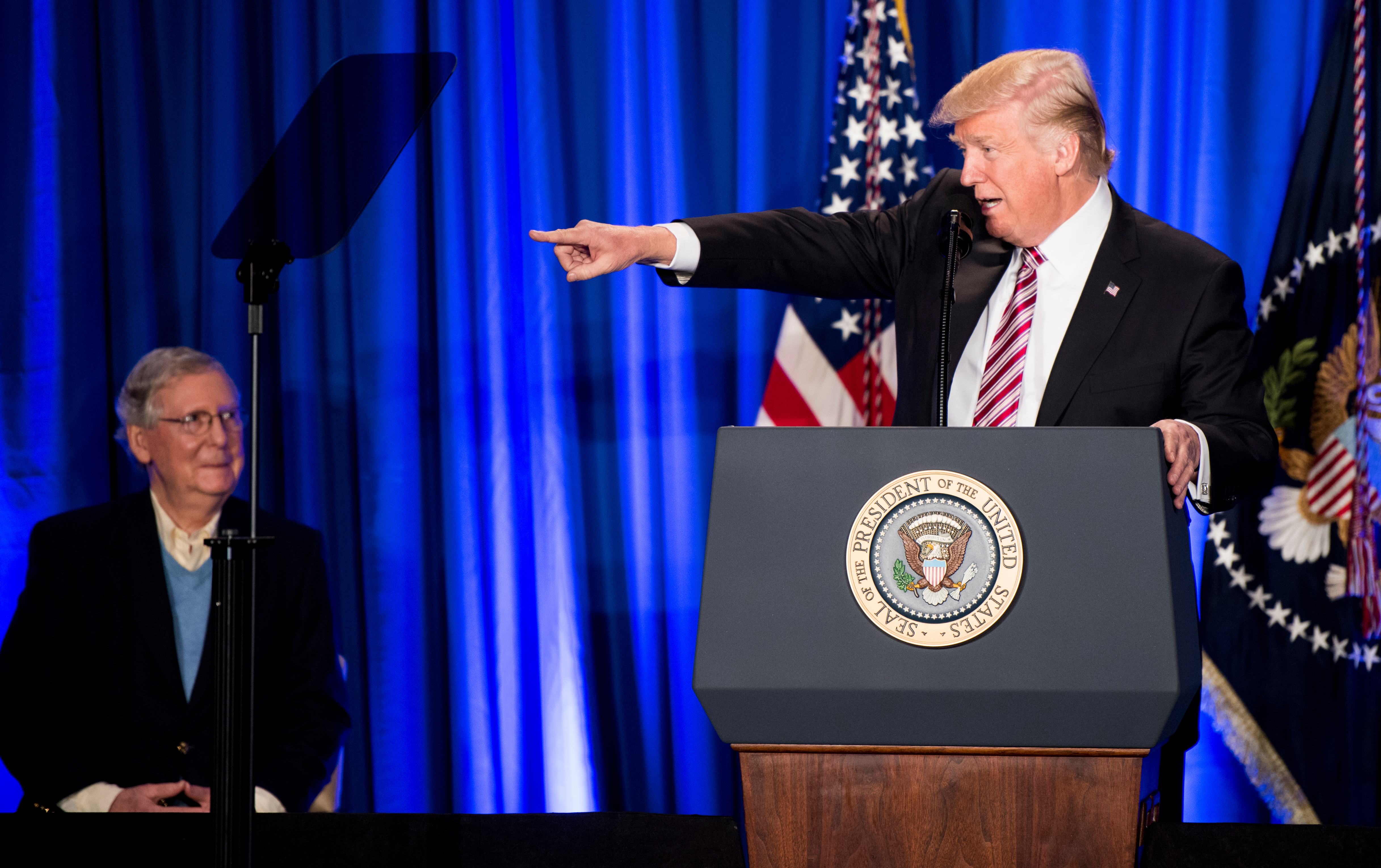 Senate Majority Leader Mitch McConnell listens as President Donald Trump speaks at the GOP Congressional retreat in Philadelphia in January. Twice on Wednesday, Trump expressed confidence in McConnell — though he hedged a bit. (Bill Clark/CQ Roll Call/Pool file photo)