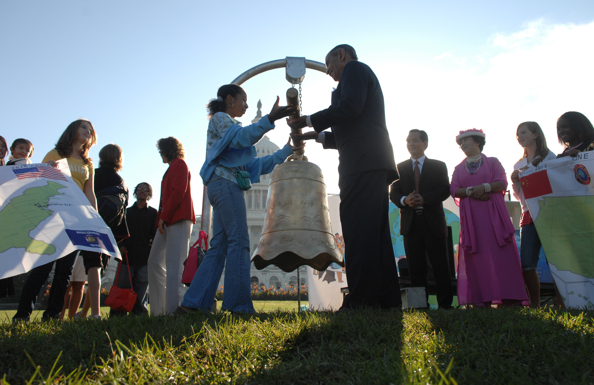 Michigan Rep. John Conyers Jr. and Meridian Witt, an 8th grader from Capitol Hill Cluster School, prepare to ring the World Harmony Bell on the Capitol Lawn, a day before the 2007 International Day of Peace. (Tom Williams/CQ Roll Call File Photo)