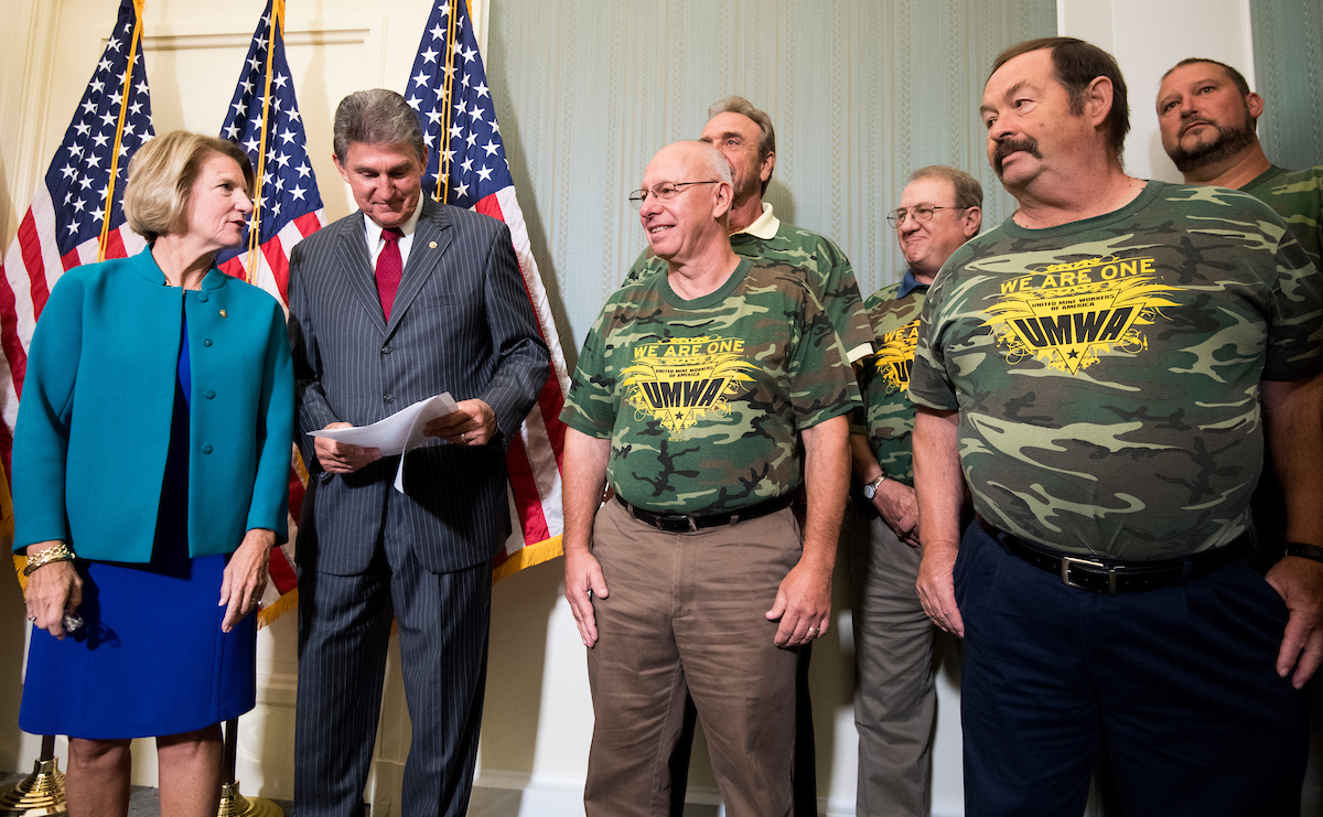 Sens. Shelley Moore Capito, R-W.Va., and Joe Manchin III, D-W. Va., talk during their press conference on the introduction of the American Miners Pension Act. (Bill Clark/CQ Roll Call)
