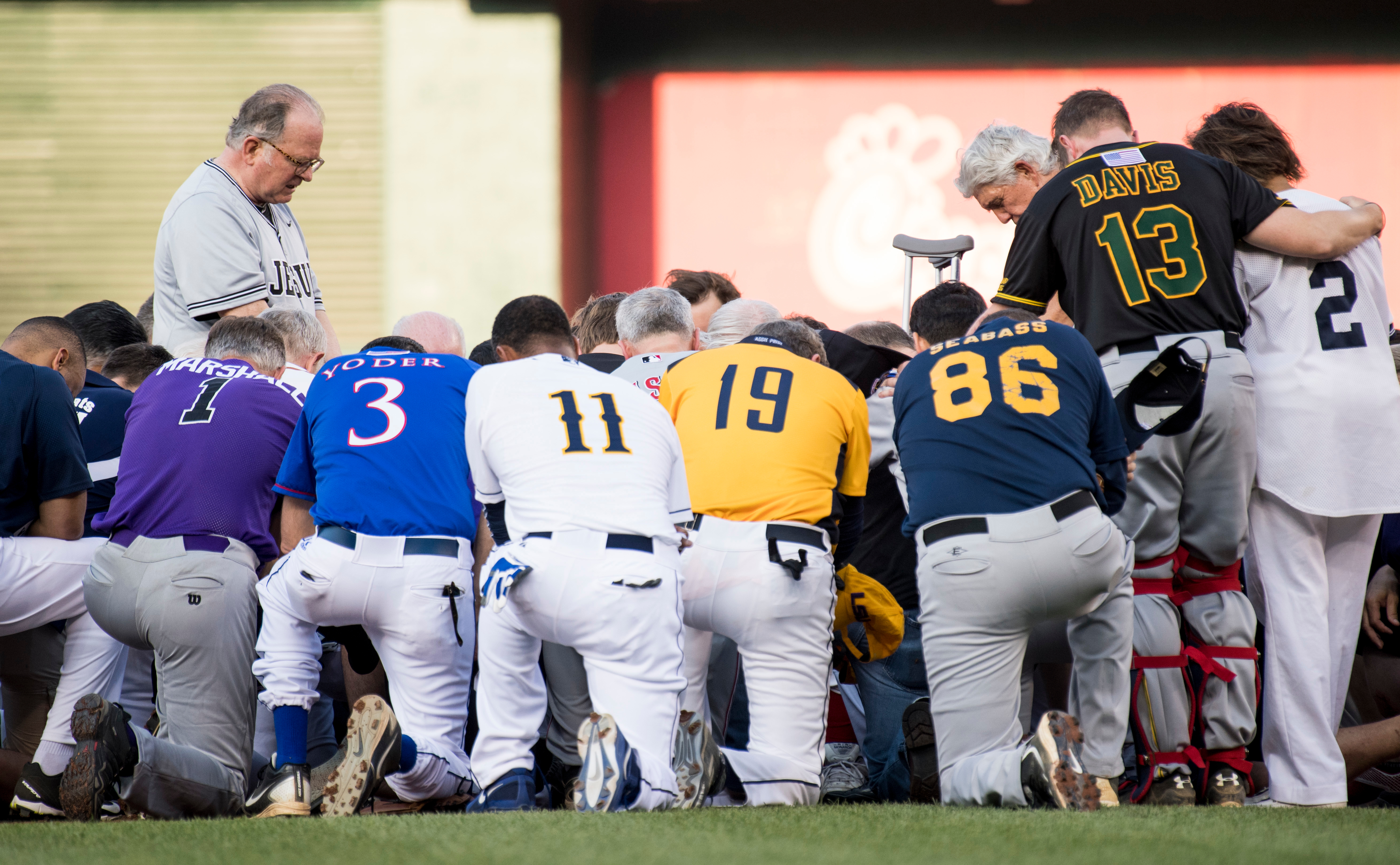 House Chaplain Patrick J. Conroy, left, leads the Republican and Democratic teams in a moment of prayer before the start of last year’s Congressional Baseball Game. (Bill Clark/CQ Roll Call file photo)