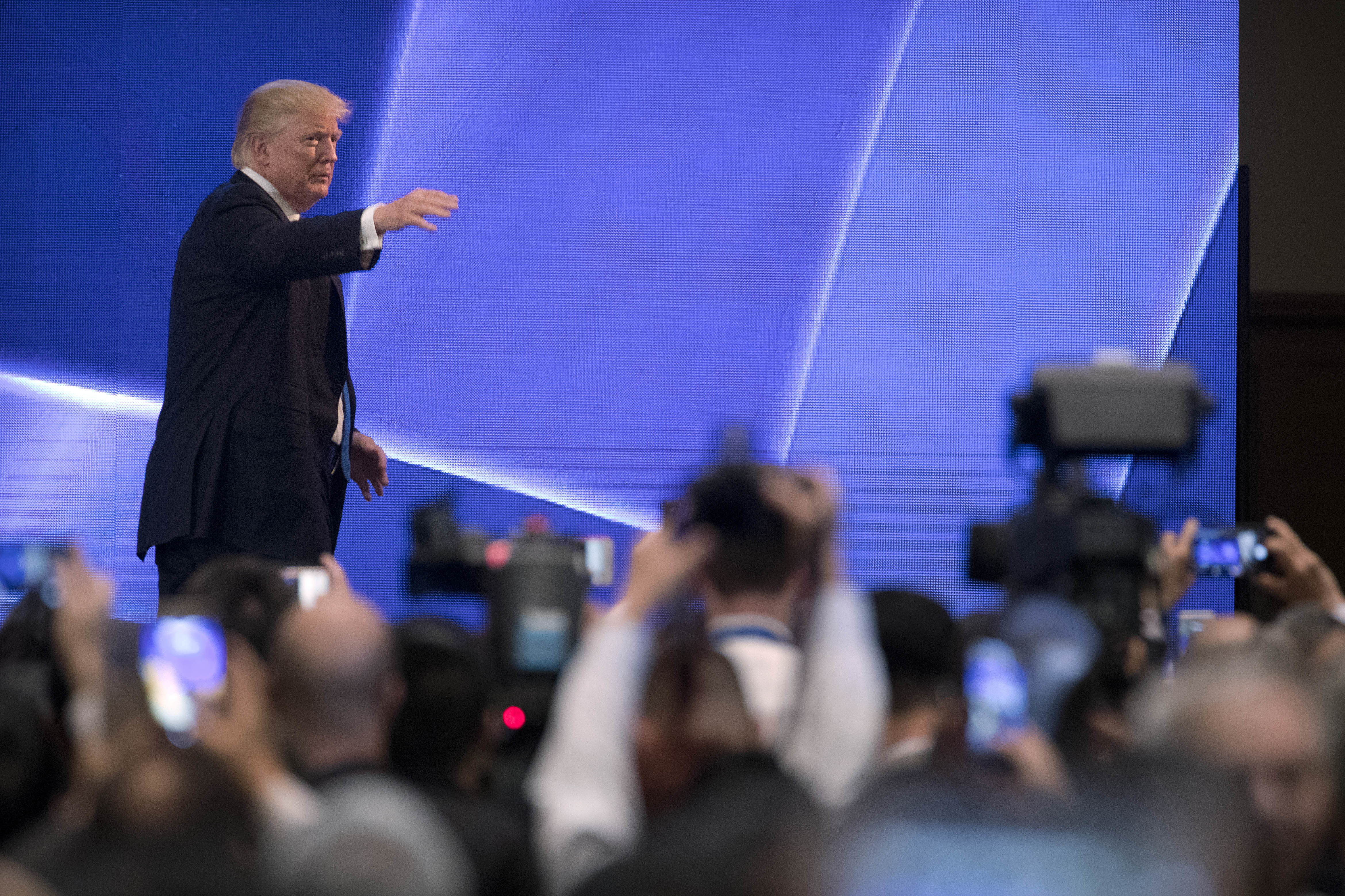 President Donald Trump waves to the audience Friday after speaking at the Asia-Pacific Economic Cooperation summit in Danang, Vietnam. (Mark Schiefelbein/AP)