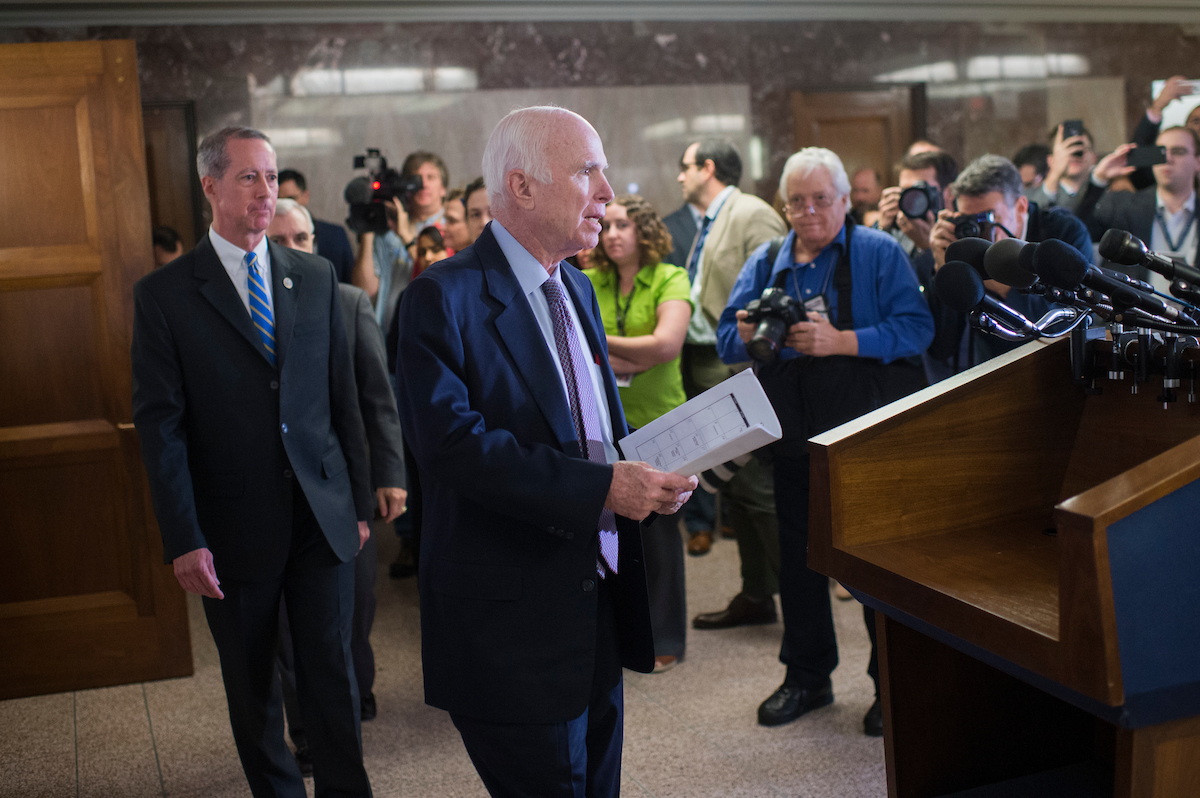 Senate Armed Services Chairman John McCain, center, and House Armed Services Chairman Mac Thornberry, left, arrive for an NDAA conference committee meeting in October. (Tom Williams/CQ Roll Call file photo)