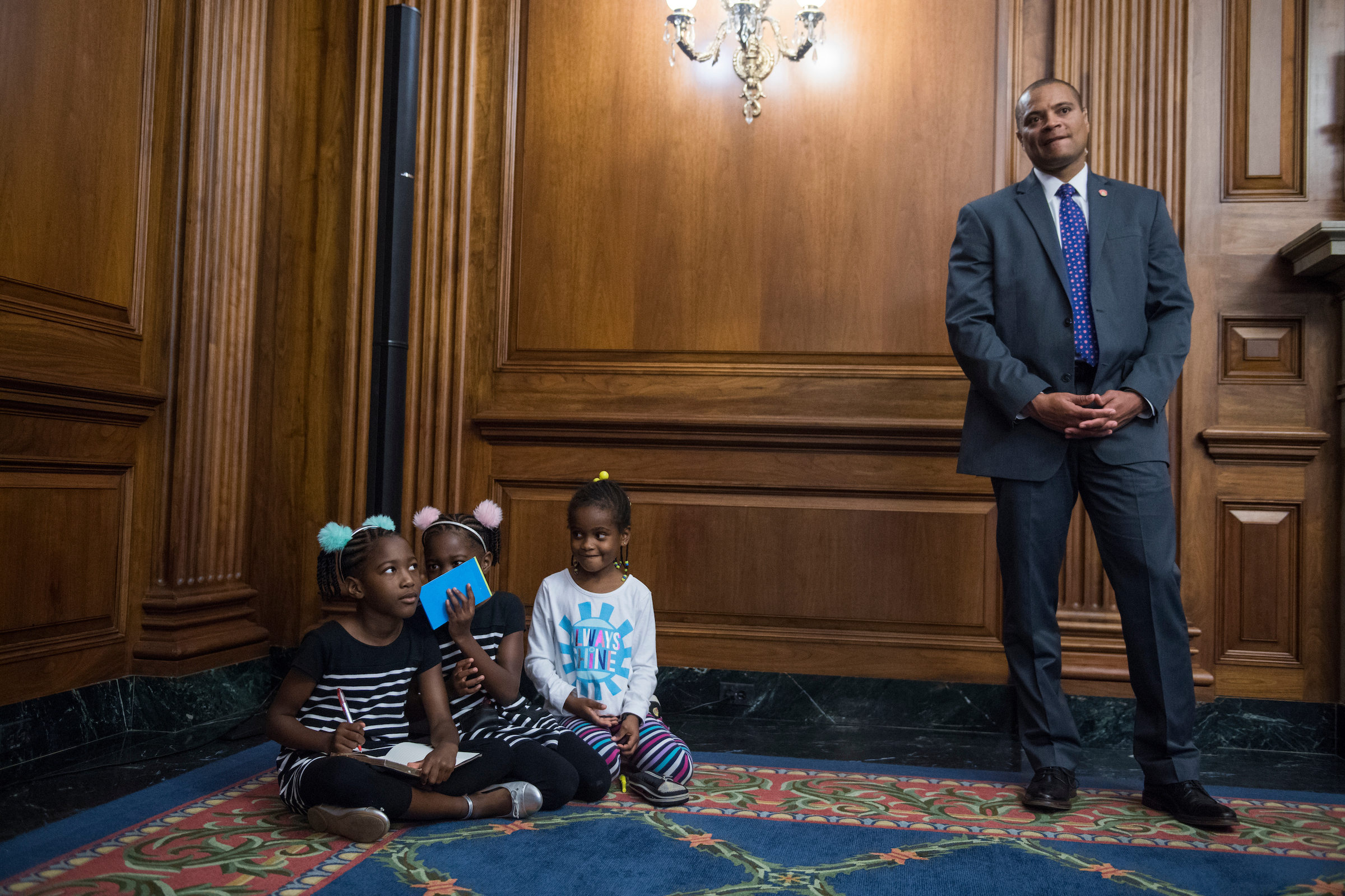 UNITED STATES - NOVEMBER 03: From left, Seilah Tappin, 7, of Bethesda, Md., her twin sister Shiloh, and friend Dani Hebron, 7, attend a news conference in the Capitol with House Minority Leader Nancy Pelosi, D-Calif., and Rep. Richard Neal, D-Mass., to voice opposition to the Republicans' tax reform plan on November 3, 2017. (Photo By Tom Williams/CQ Roll Call)