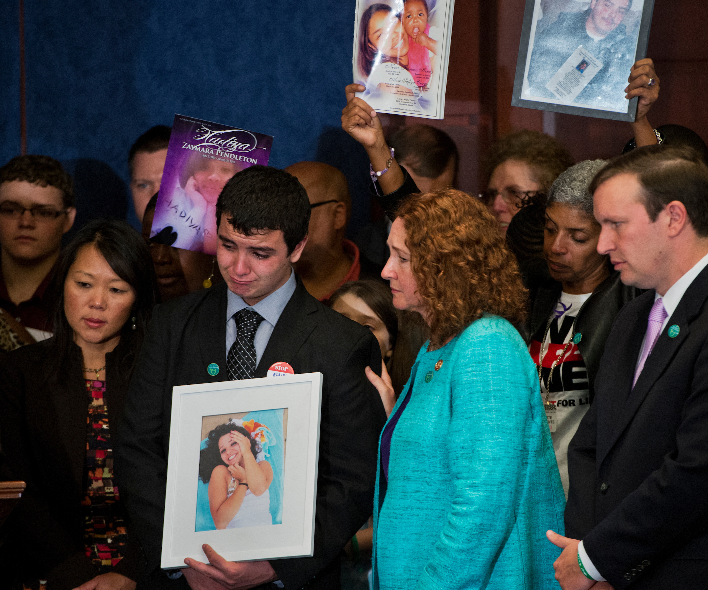 UNITED STATES - SEPTEMBER 18: Rep. Elizabeth Esty, D-Conn., comforts Carlos Soto, whose sister Victoria was a teacher killed in the Sandy Hook Elementary shooting, during an event in the Capitol Visitor Center to call on Congress to act on gun control legislation. Sen. Chris Murphy, D-Conn., appears at right. (Photo By Tom Williams/CQ Roll Call)