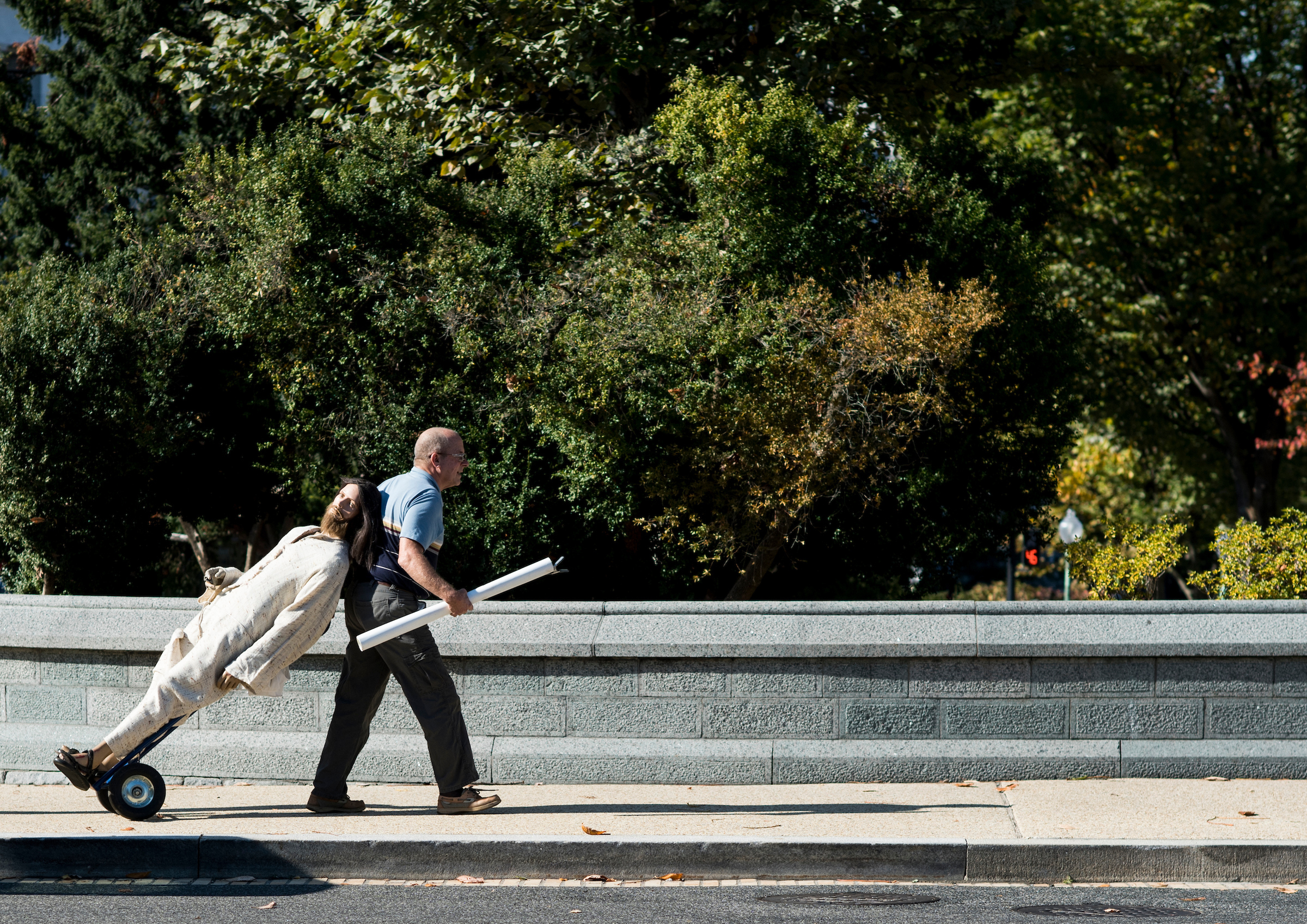 UNITED STATES - NOVEMBER 2: Every Thursday Rita Warren, aka Jesus Lady, sets up a mannequin dressed as Jesus at the Capitol. One of her helps is shown wheeling the mannequin to the Capitol on Thursday, Nov. 2, 2017. (Photo By Bill Clark/CQ Roll Call)