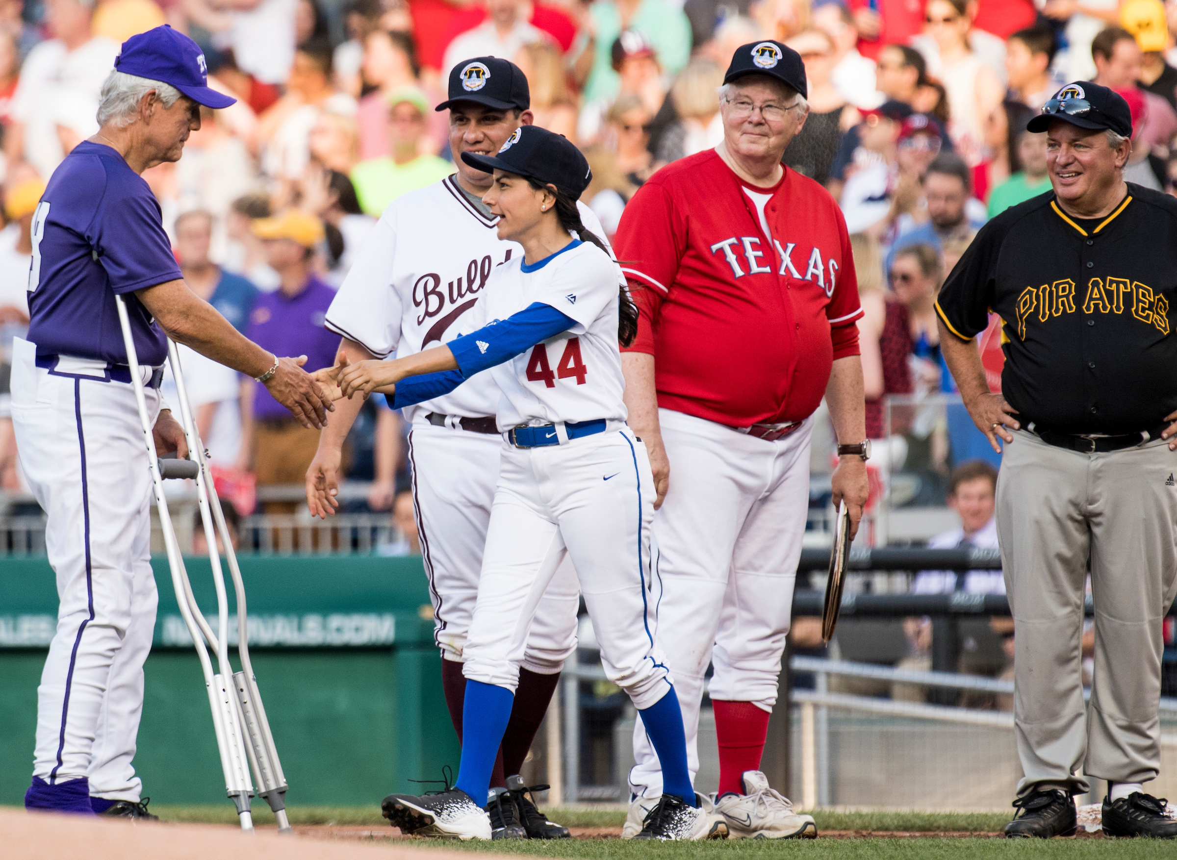 Rep. Joe L. Barton, R-Texas, in Texas uniform, watches as Rep. Nanette Barragan, D-Calif., shakes hands with Rep. Roger Williams, R-Texas, during player introductions during this year’s Congressional Baseball Game. (Bill Clark/CQ Roll Call file photo)