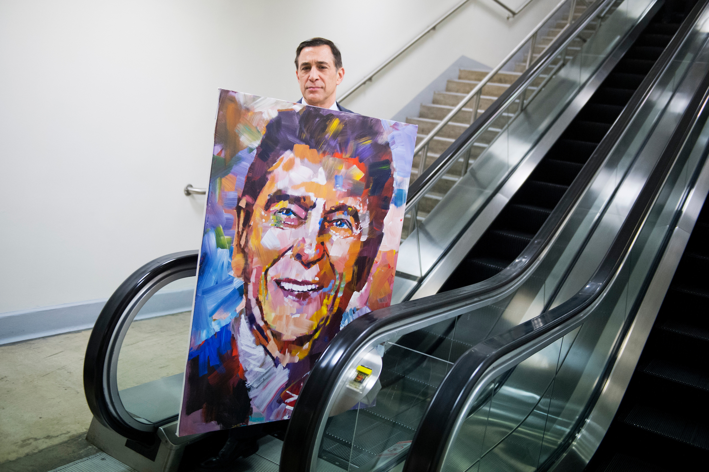 Rep. Darrell Issa, R-Calif., seen here with a painting of Ronald Reagan by artist Steve Penley, will retire at the end of this term. (Tom Williams/CQ Roll Call file photo)