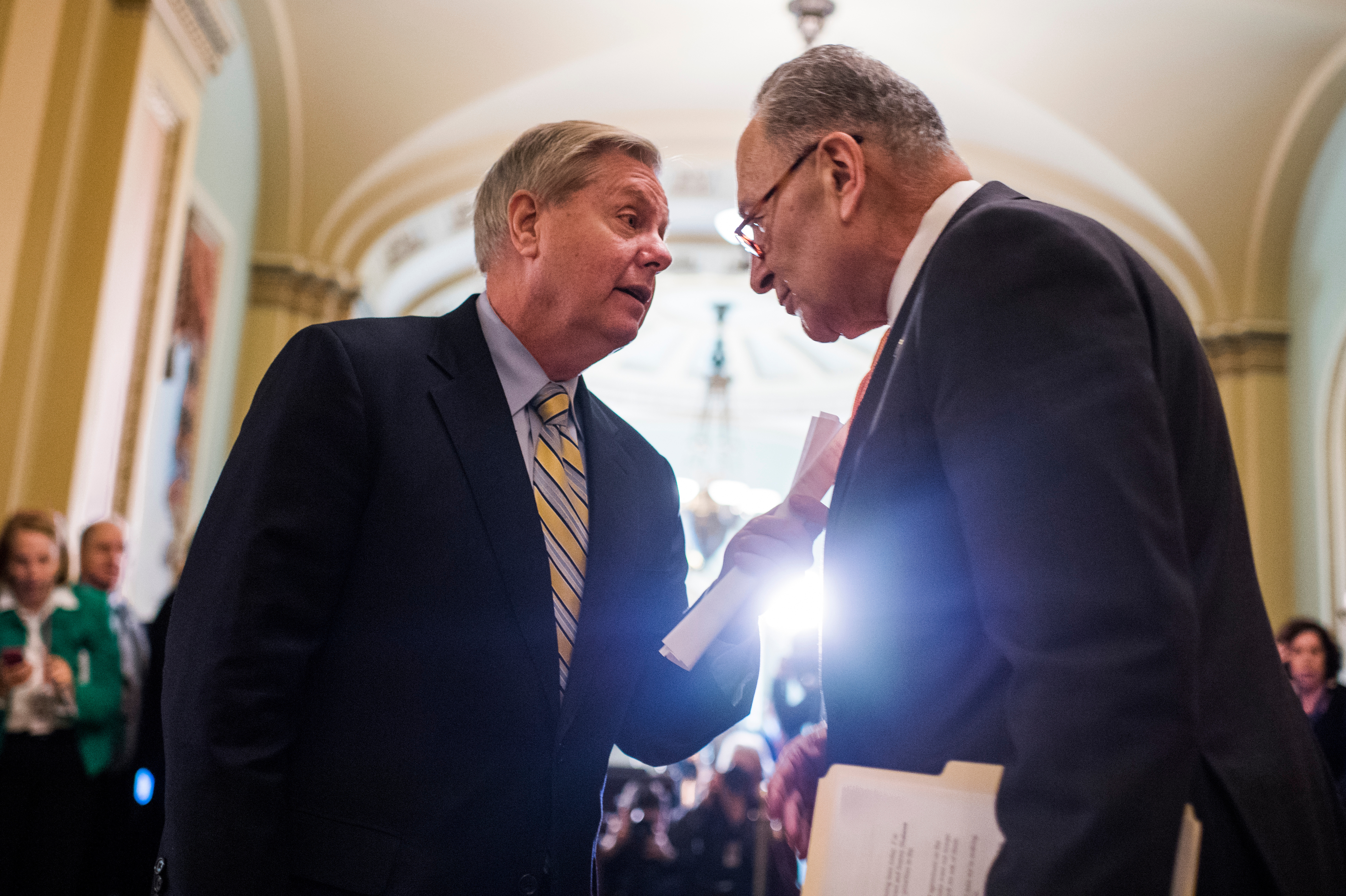 South Carolina Sen. Lindsey Graham and Senate Minority Leader Charles E. Schumer confer after the Senate policy lunches in the Capitol on Tuesday. (Tom Williams/CQ Roll Call)