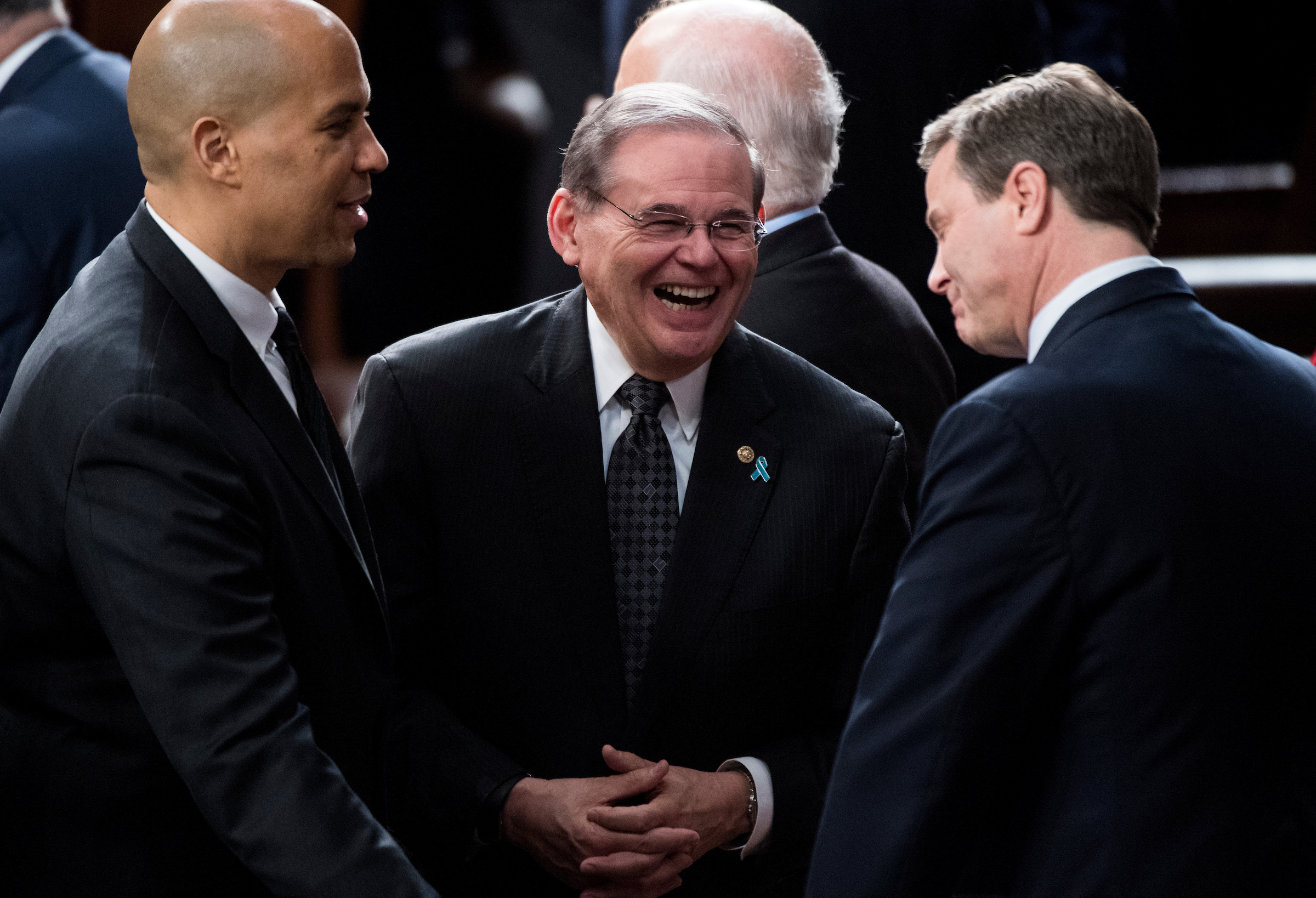 UNITED STATES - JANUARY 30: From left, Sen. Cory Booker, D-N.J., Sen. Bob Menendez, D-N.J., and Rep. Donald Norcross, D-N.J., talk before the start of President Donald Trump's State of the Union Address to the joint session of Congress in the Capitol on Tuesday, Jan. 30, 2018. (Photo By Bill Clark/CQ Roll Call)