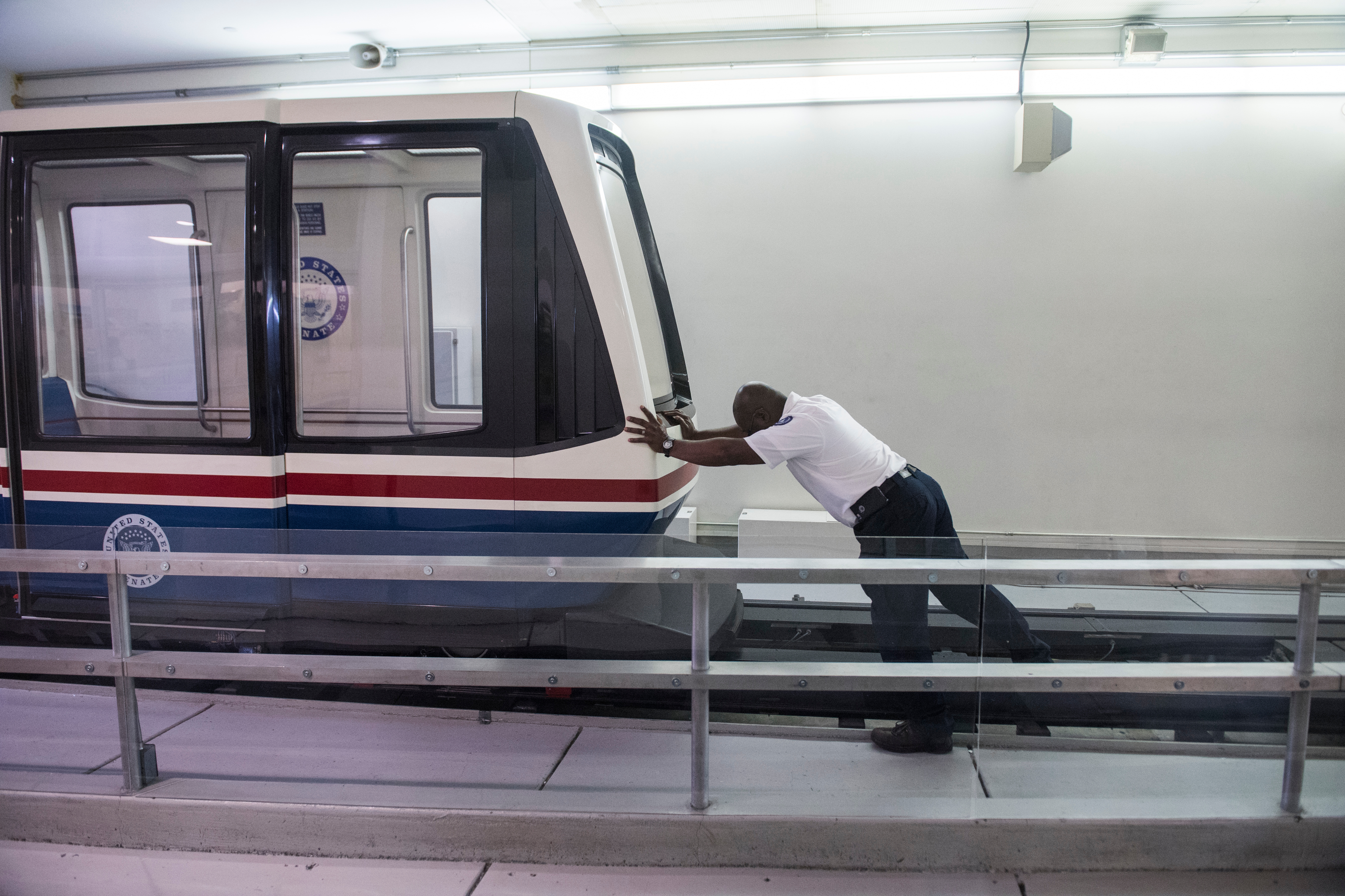 UNITED STATES - JANUARY 19: A worker pushes a senate subway car Friday morning as the Senate considers the House passed continuing resolution to fund the government on January 19, 2018. (Photo By Tom Williams/CQ Roll Call)
