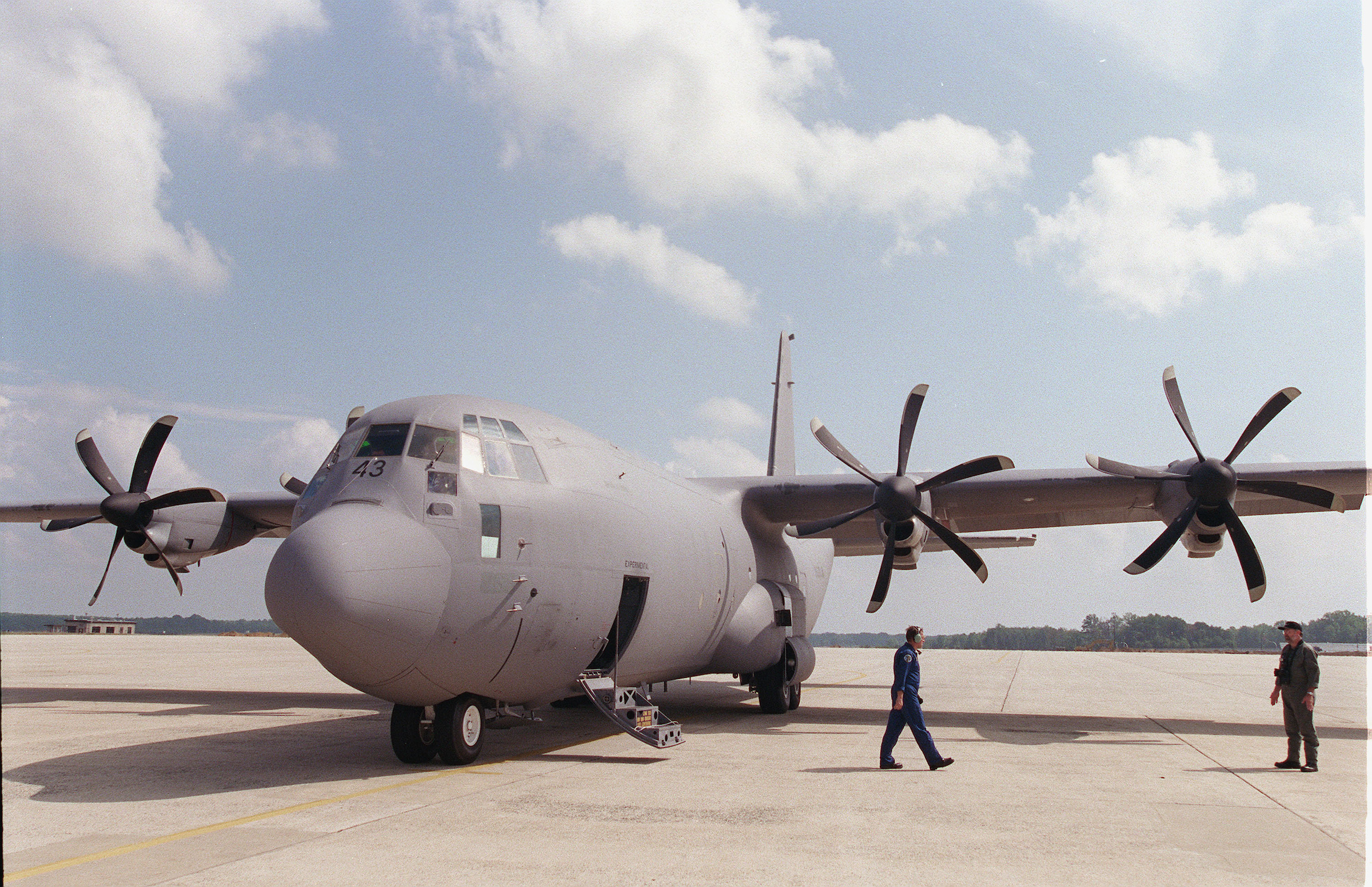 Lockheed Martin crew members stand by a C-130J-30 Hercules cargo plane on the tarmac at Andrews Air Force Base. (Scott J. Ferrell/CQ Roll Call)