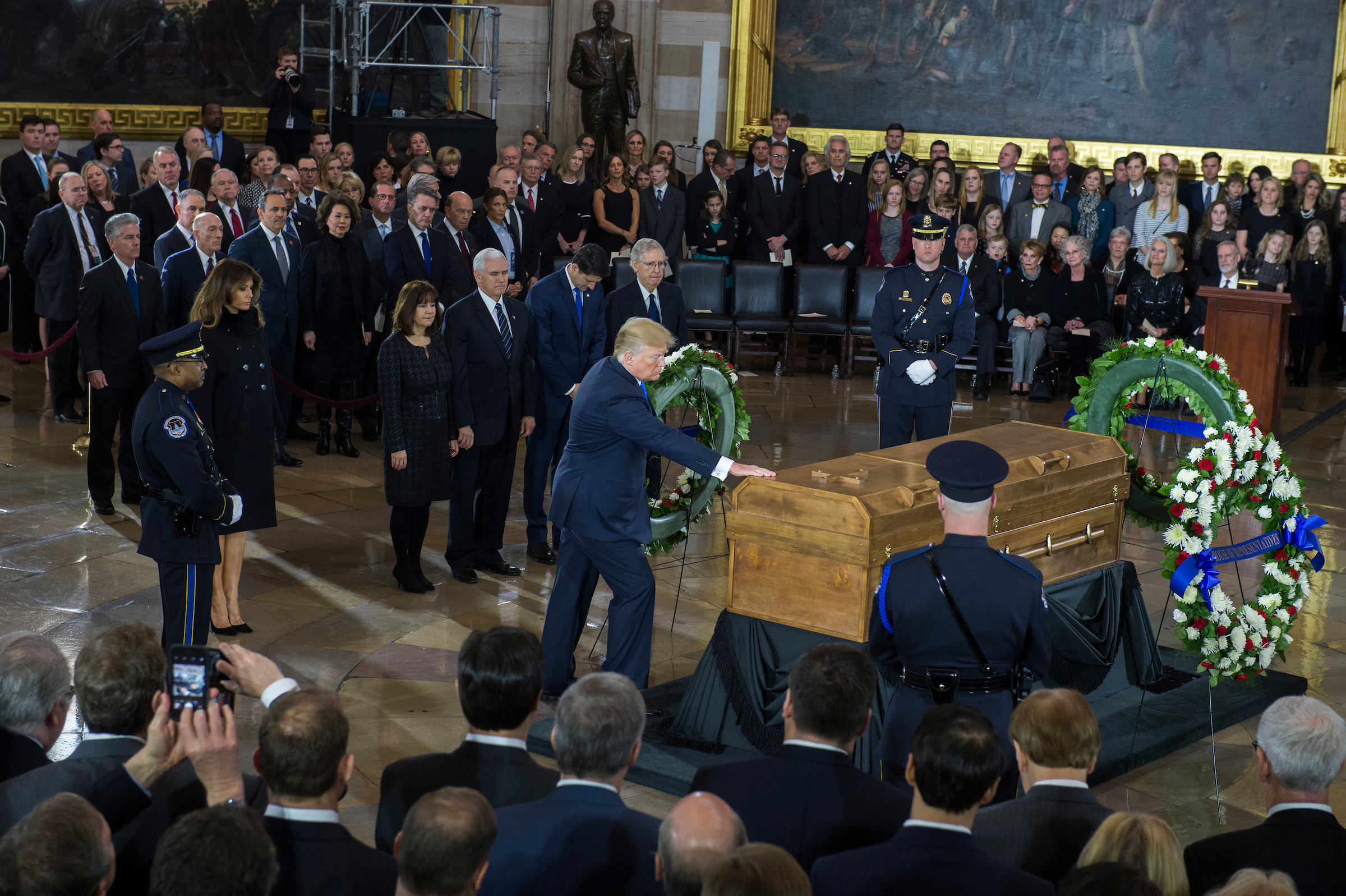 UNITED STATES - FEBRUARY 28: President Donald Trump touches the casket of the late Rev. Billy Graham as the body of Graham lies in honor in the Capitol Rotunda on February 28, 2018. (Photo By Tom Williams/CQ Roll Call)