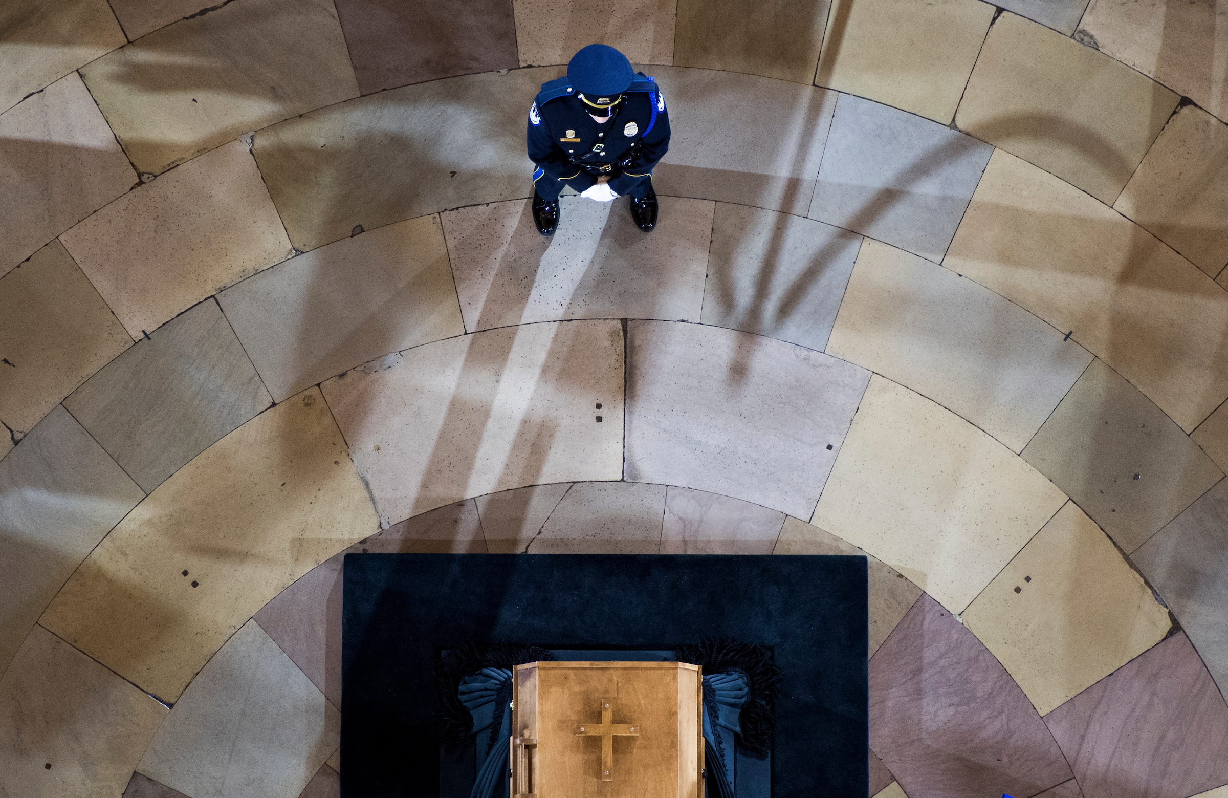 UNITED STATES - FEBRUARY 28: A U.S. Capitol Police officer stands guard at Rev. Billy Graham's casket as his body lies in honor in the Capitol Rotunda on Wednesday, Feb. 28, 2018. (Photo By Bill Clark/CQ Roll Call)