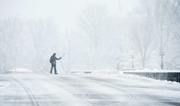 A tourist takes a selfie in front of the Capitol during the snow storm. (Bill Clark/CQ Roll Call)