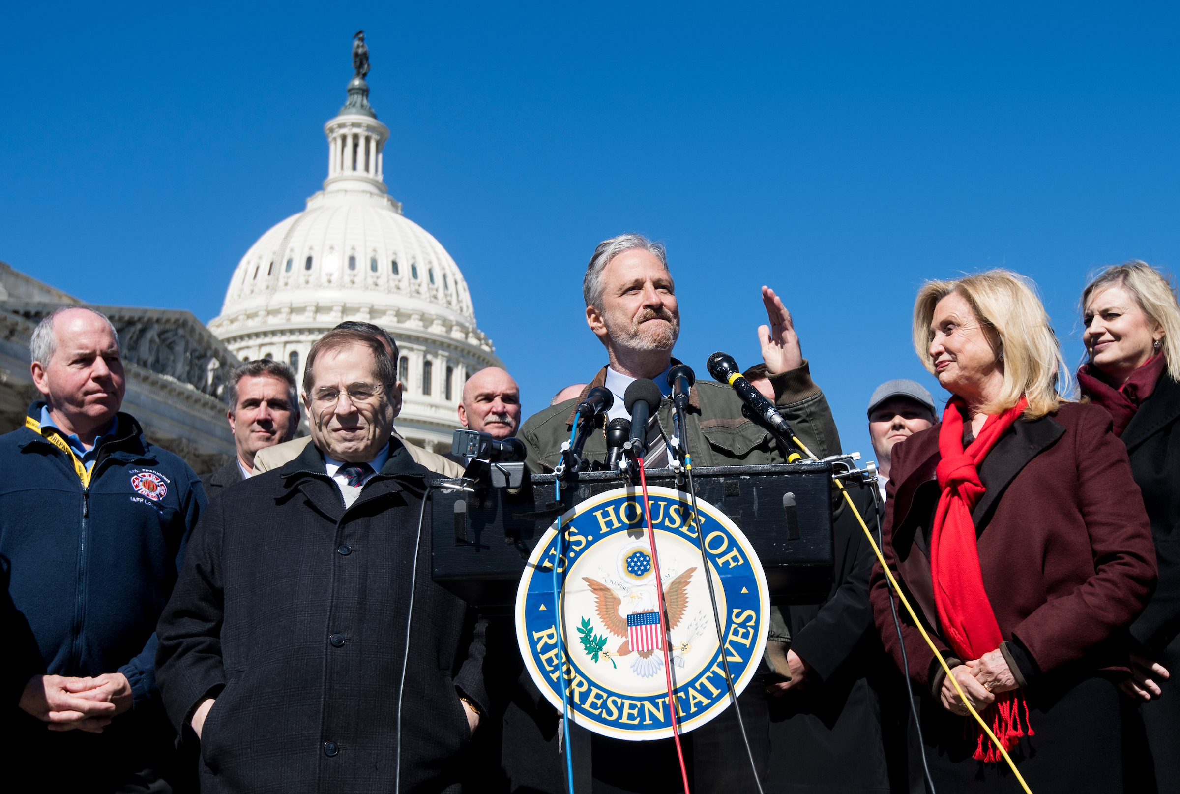 Comedian Jon Stewart, center, flanked by New York Reps. Carolyn B. Maloney and Jerrold Nadler, speaks during a press conference on March 5, calling on OMB Director Mick Mulvaney to withdraw his proposal to separate the World Trade Center Health Program from the direction of the National Institute of Occupational Safety and Health direction. (Bill Clark/CQ Roll Call)