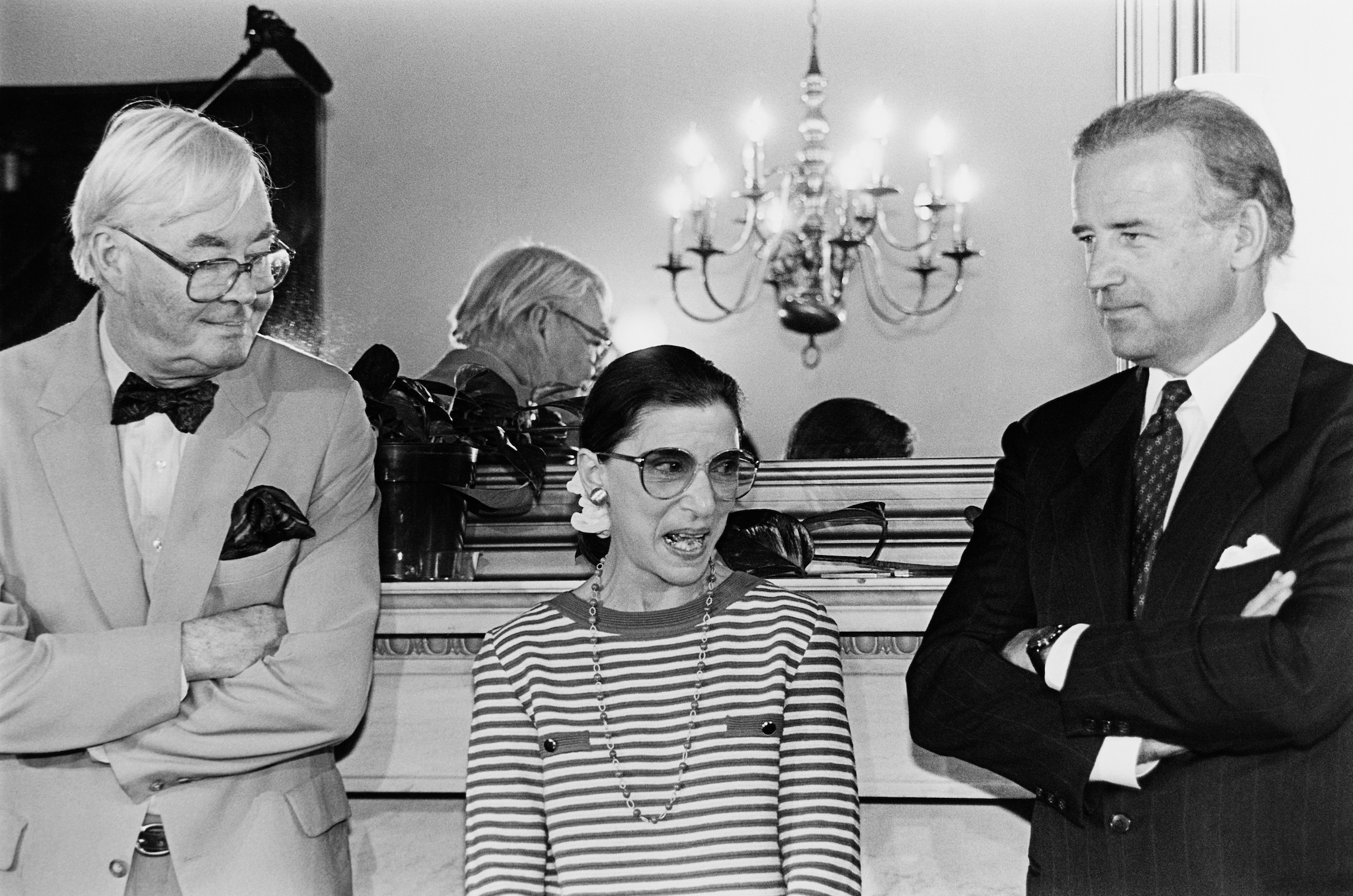 Supreme Court nominee Ruth Bader Ginsburg answering reporter's questions during courtesy call to Senator Joe Biden's office. She's standing with Sens. Biden and Daniel Patrick Moynihan, D-N.Y. June 15, 1993 (Photo by CQ Roll Call)
