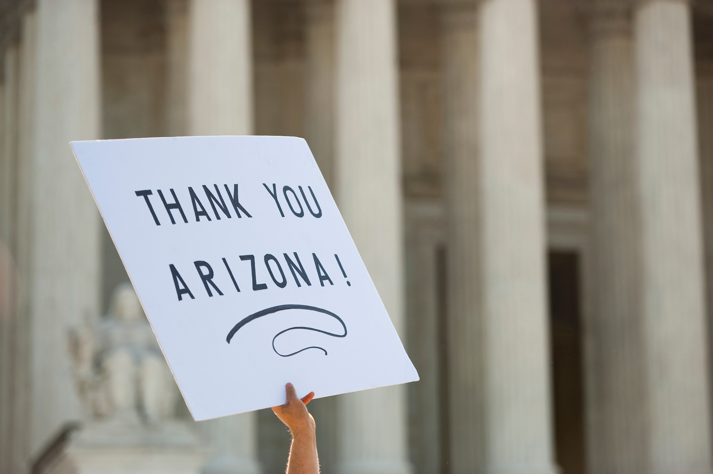 UNITED STATES APRIL 25: Protesters for and against Arizona's immigration law SB1070 rally outside of the Supreme Court as the court prepares to hear the United States v. Arizona case on Wednesday, April 25, 2012. (Photo By Bill Clark/CQ Roll Call)
