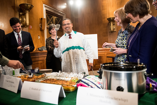 UNITED STATES - APRIL 25: Rep. Keith Ellison, D-Minn., wears a apron while holding a spatula during the eighth annual Minnesota Congressional Delegation Hotdish Competition in the Dirksen Senate Office Building on Wednesday, April 25, 2018. (Photo By Bill Clark/CQ Roll Call)