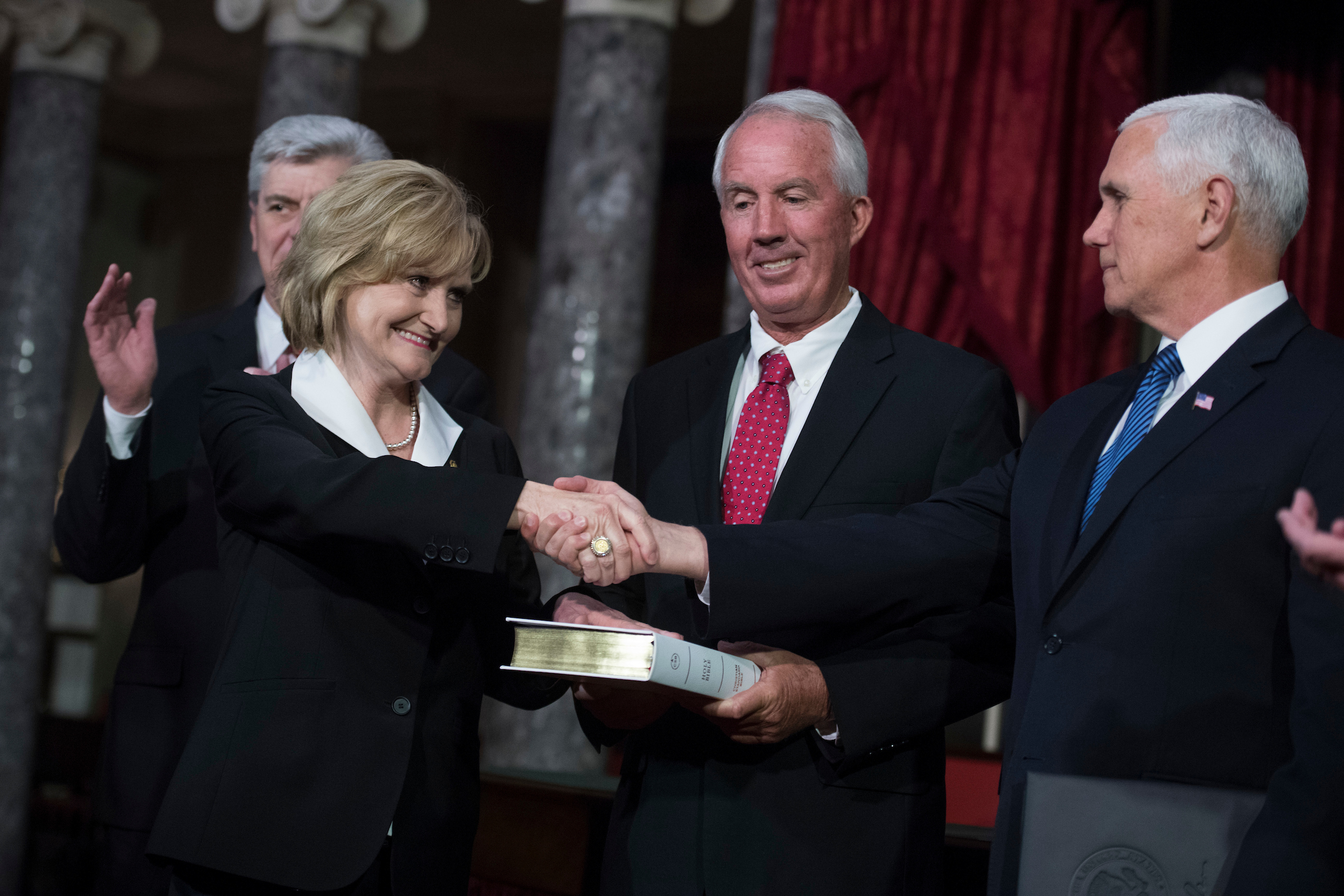 Sen. Cindy Hyde-Smith, R-Miss., participates Monday in a mock swearing-in ceremony in the Capitol’s Old Senate Chamber with Vice President Mike Pence and her husband Michael Smith. (Tom Williams/CQ Roll Call)